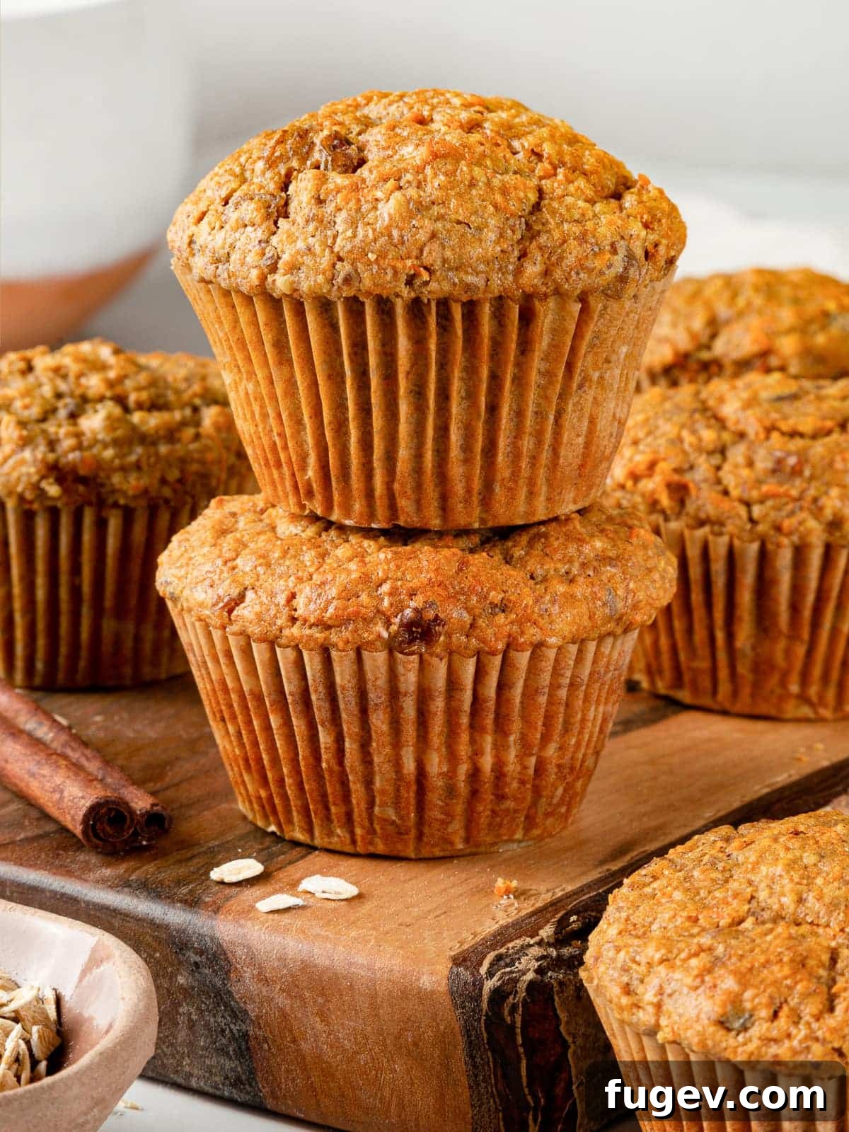Wholesome Carrot Muffins 14 Two healthy carrot muffins stacked on a plate with visible golden tops and wholesome texture, ready to be enjoyed.