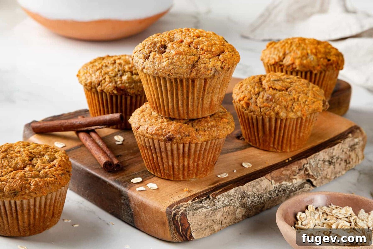 Wholesome Carrot Muffins 3 A group of freshly baked healthy carrot muffins beautifully arranged on a rustic wooden cutting board, showcasing their golden-brown tops and hearty texture.