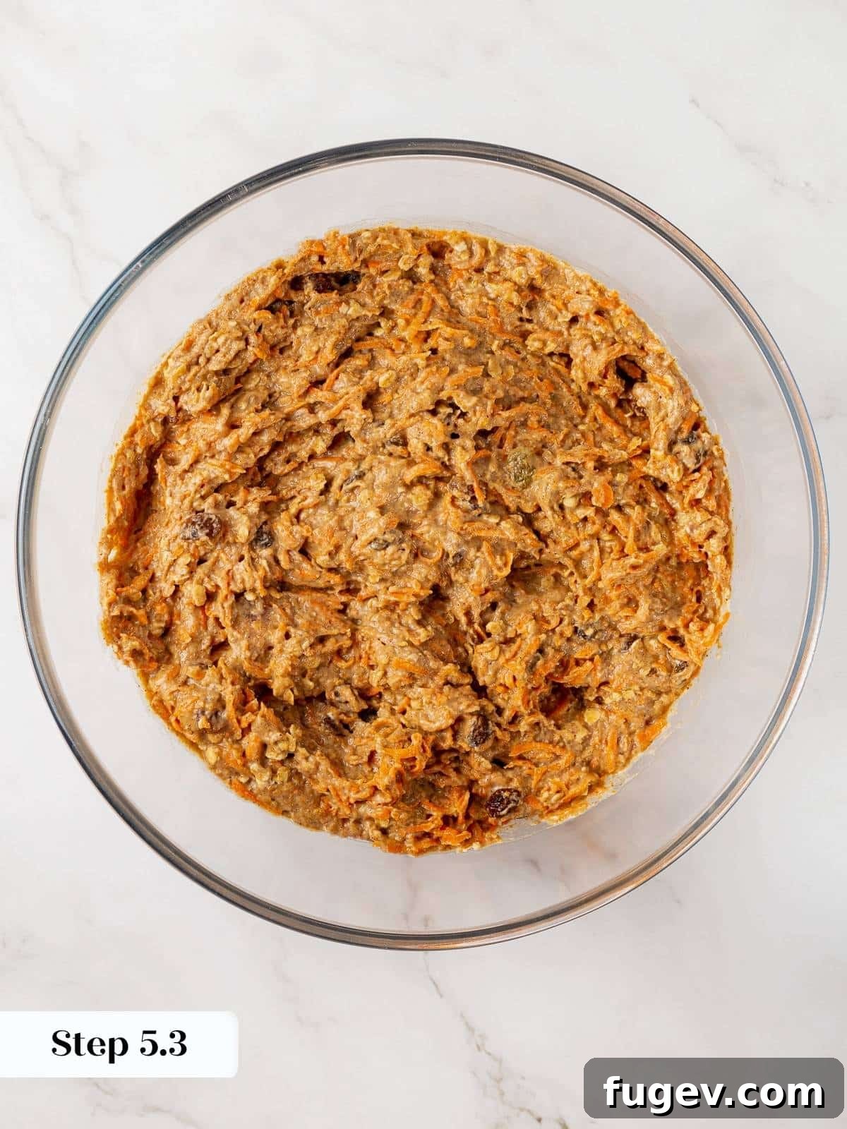 Wholesome Carrot Muffins 10 The final healthy carrot muffin batter, rich with grated carrots and other ingredients, ready for baking.