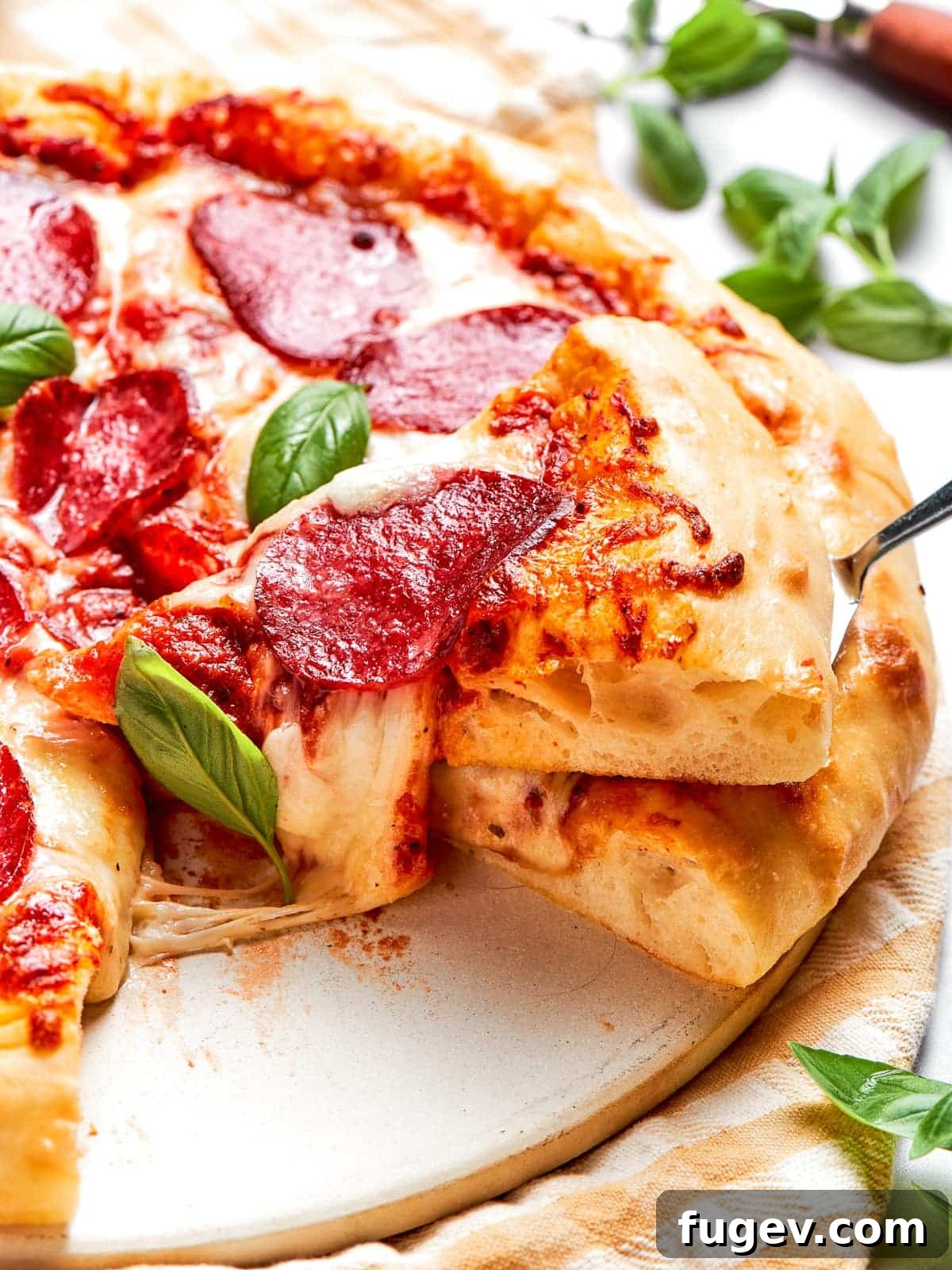 Zesty Pepperoni Delight 2 Cheese stretching between two pizza slices mid-pull.