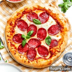 Zesty Pepperoni Delight 12 Close-up of golden, crisp crust on baked pepperoni pizza.
