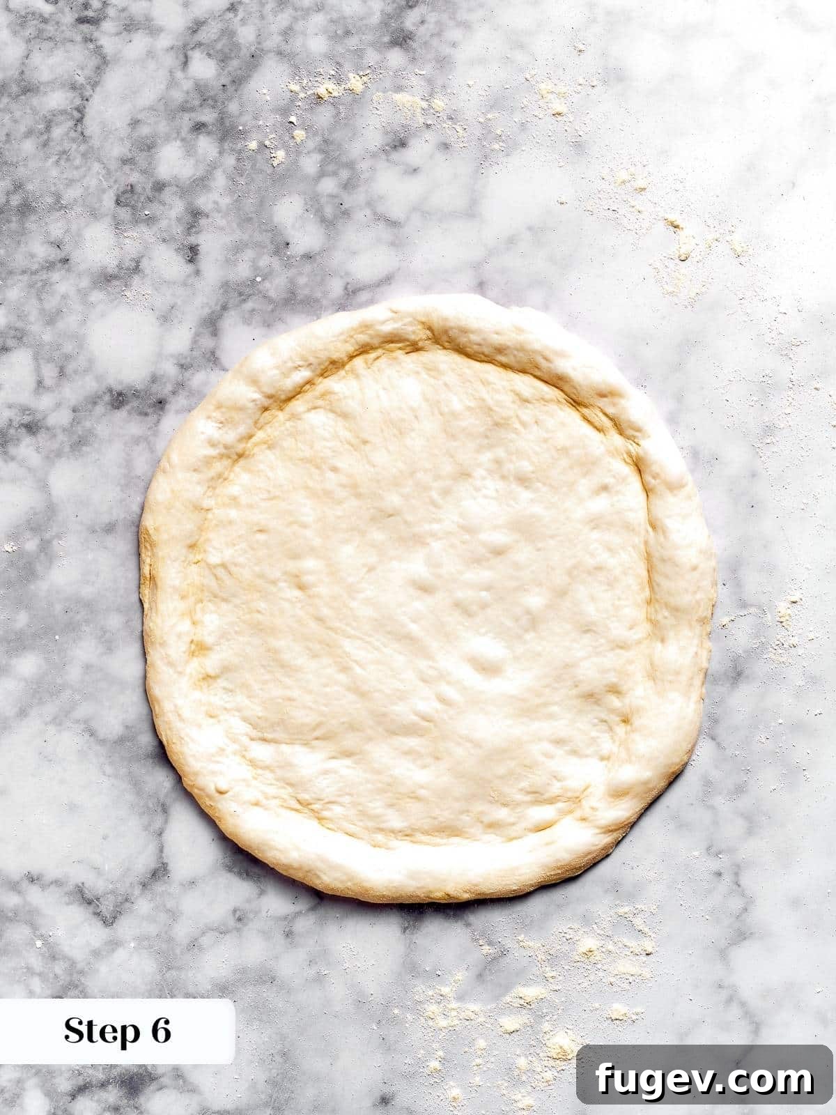 Zesty Pepperoni Delight 5 Pizza dough shaped into a circle on a floured surface.