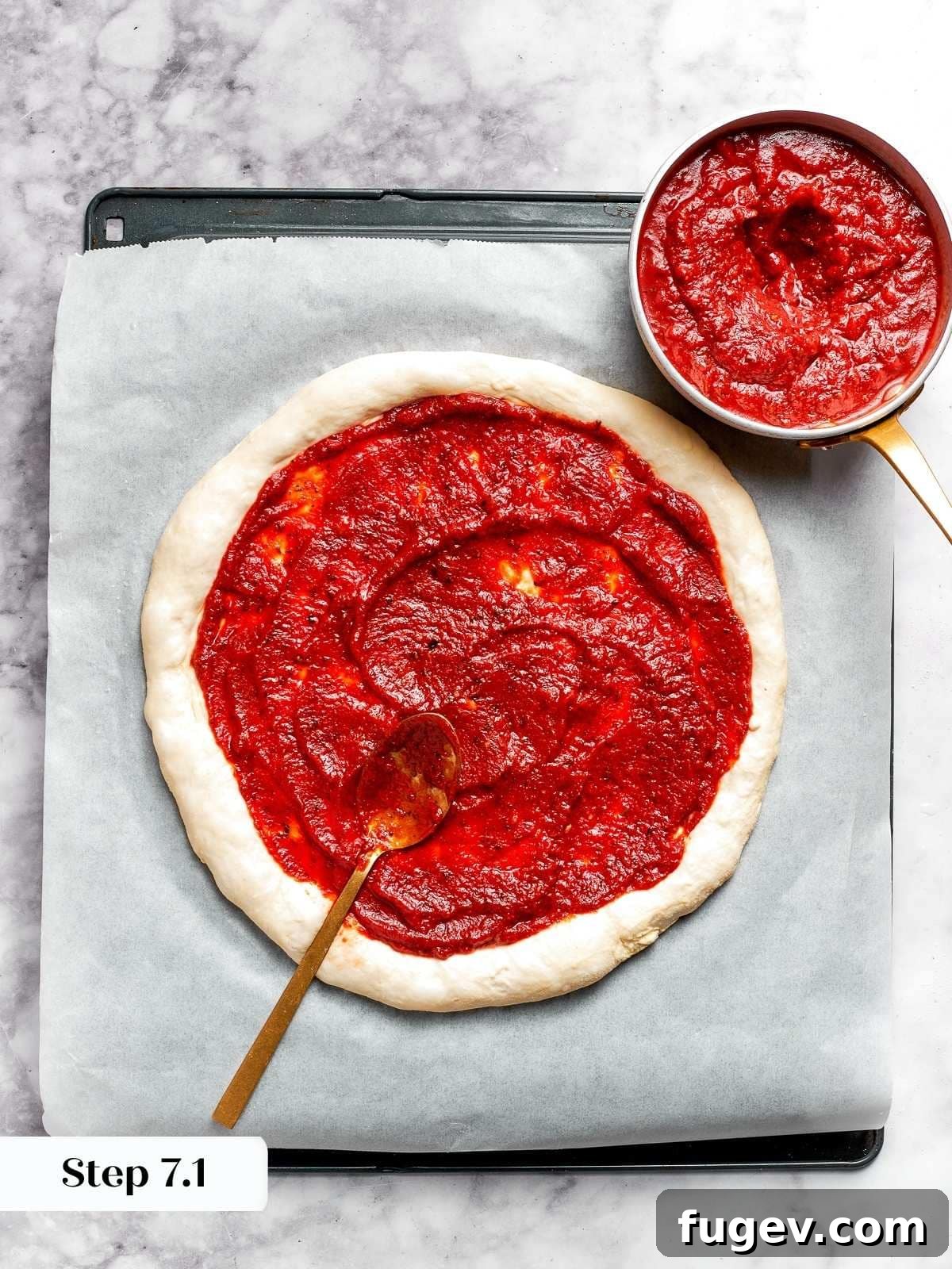Zesty Pepperoni Delight 6 Tomato pizza sauce being spread onto round pizza dough.