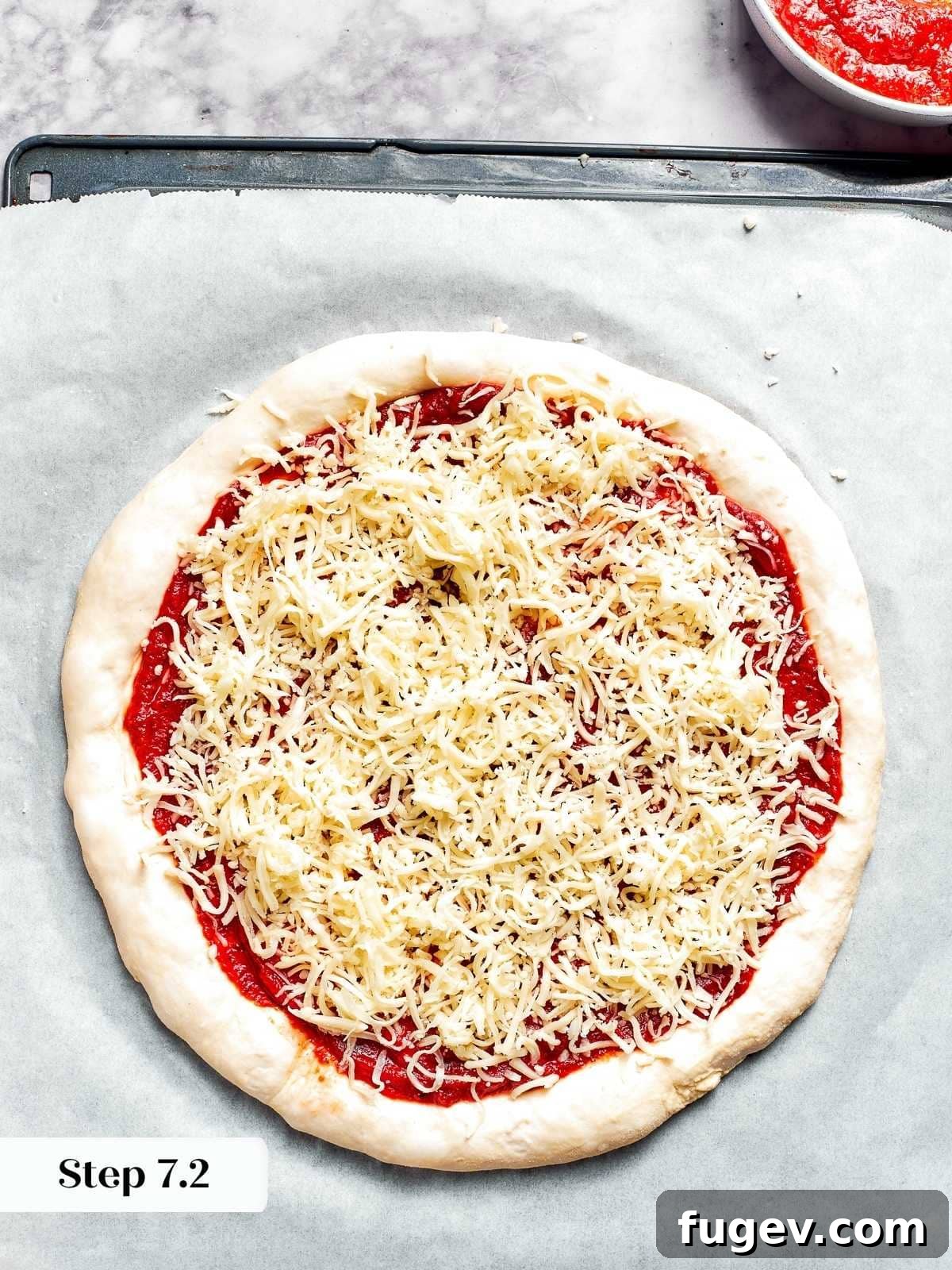 Zesty Pepperoni Delight 7 Cheese evenly distributed on top of unbaked pizza crust.