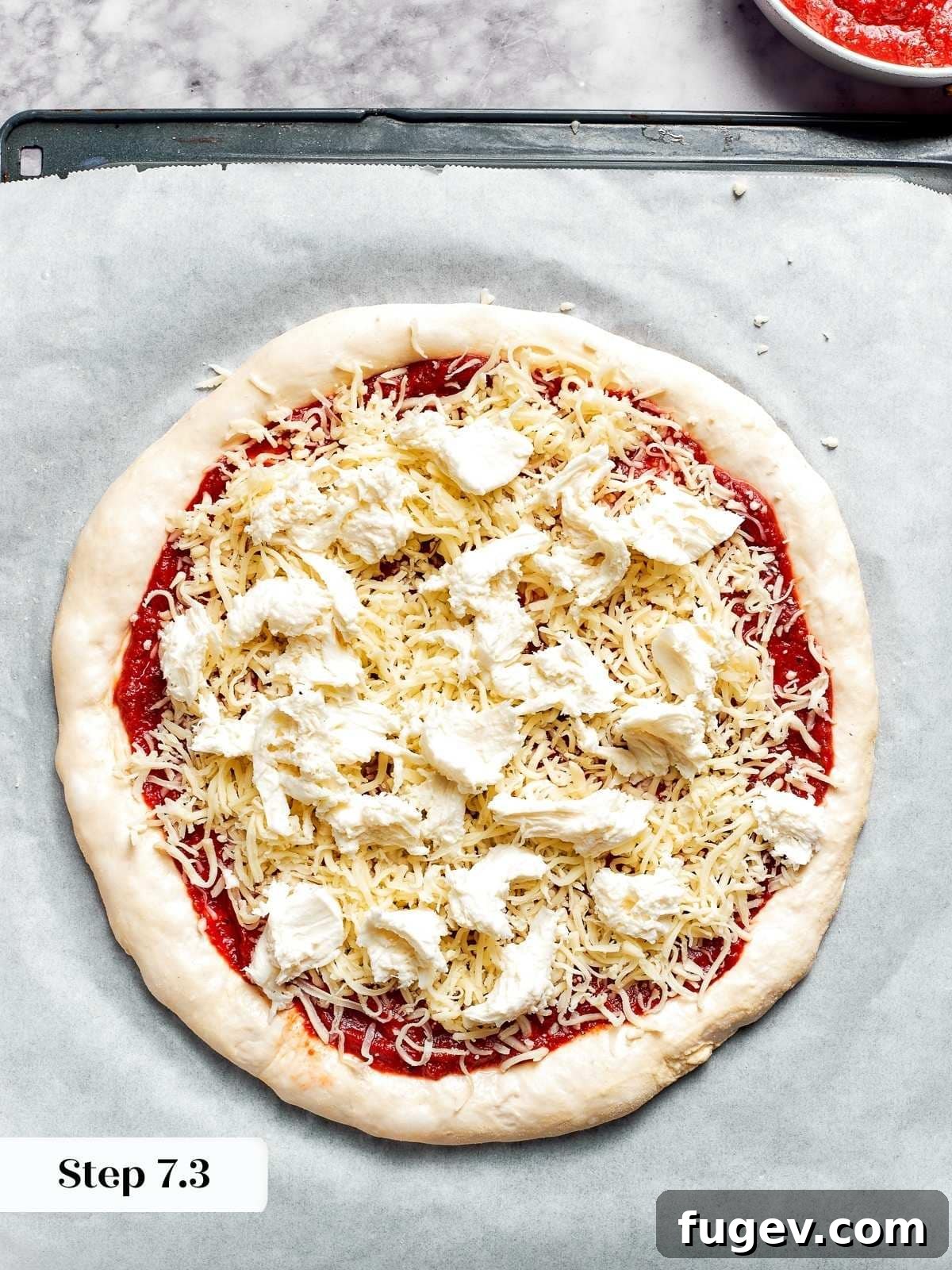 Zesty Pepperoni Delight 8 Topping the pizza dough with fresh mozzarella before baking.