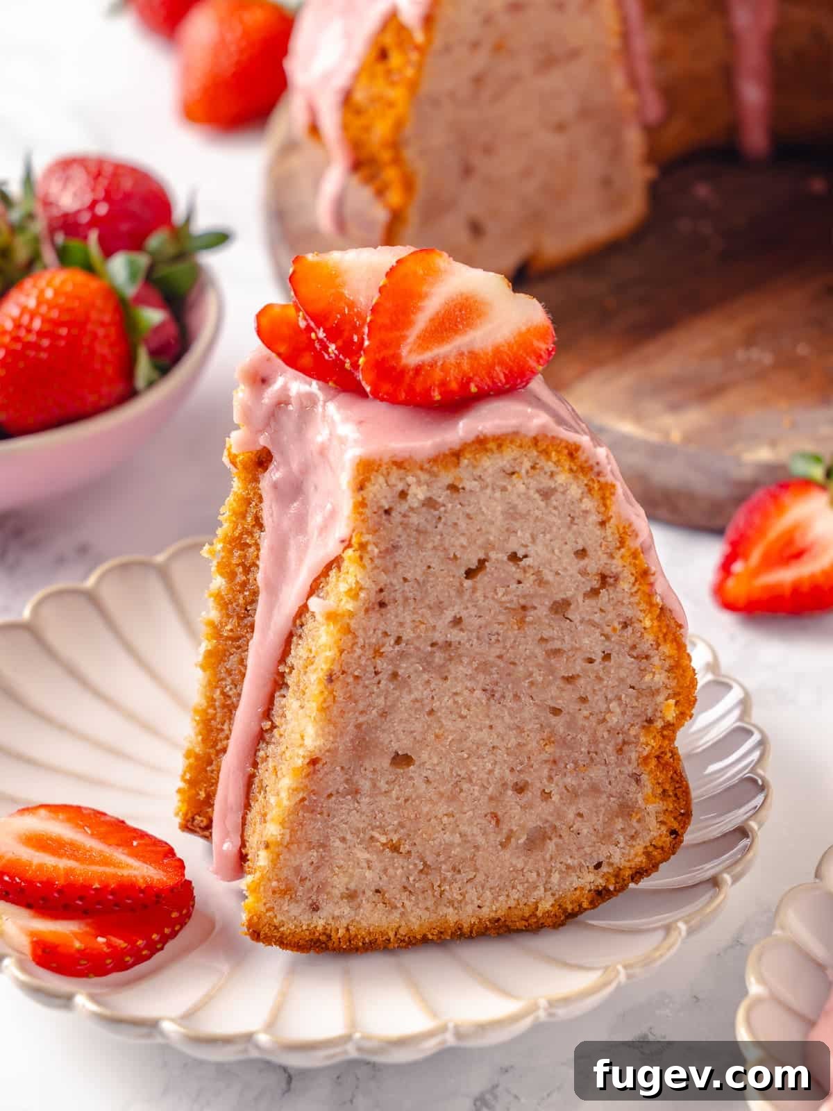 Strawberry Bliss Pound Cake 2 A single, perfectly sliced piece of strawberry pound cake, generously drizzled with a sweet glaze and elegantly presented, inviting you to enjoy its rich flavor.