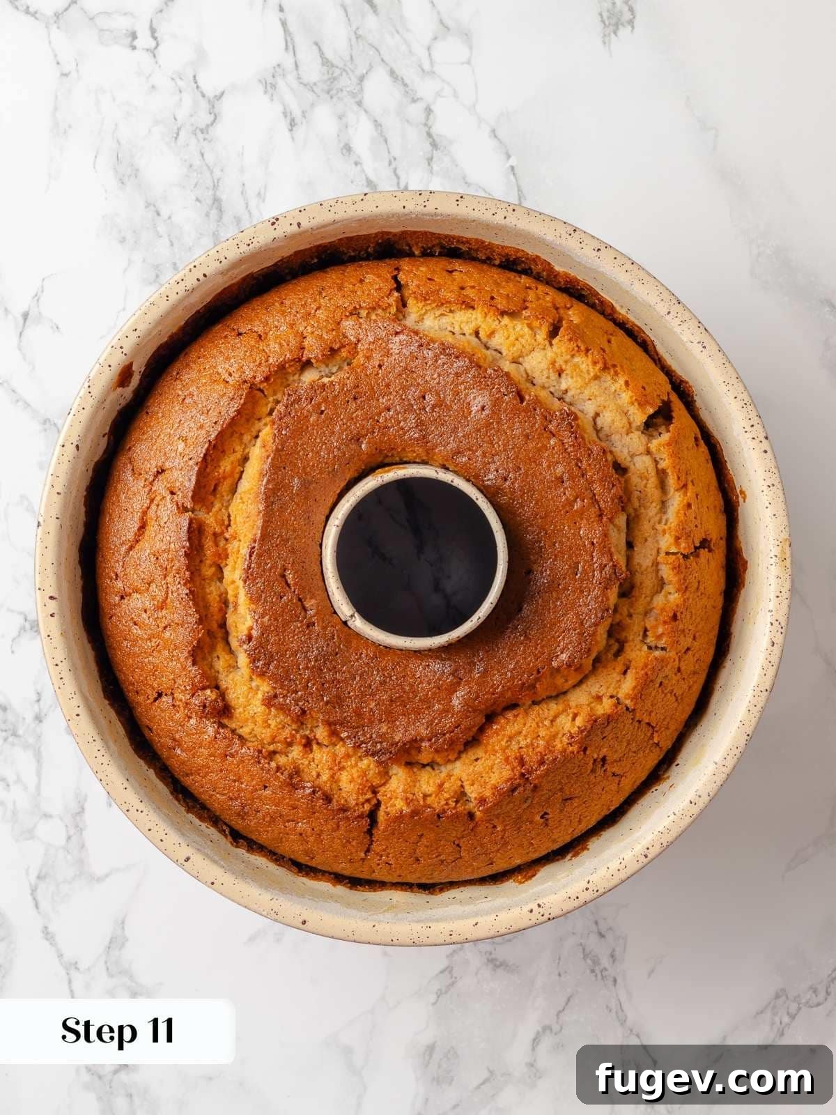Strawberry Bliss Pound Cake 17 A beautifully golden brown strawberry pound cake, freshly baked and still warm, resting elegantly in its bundt pan.