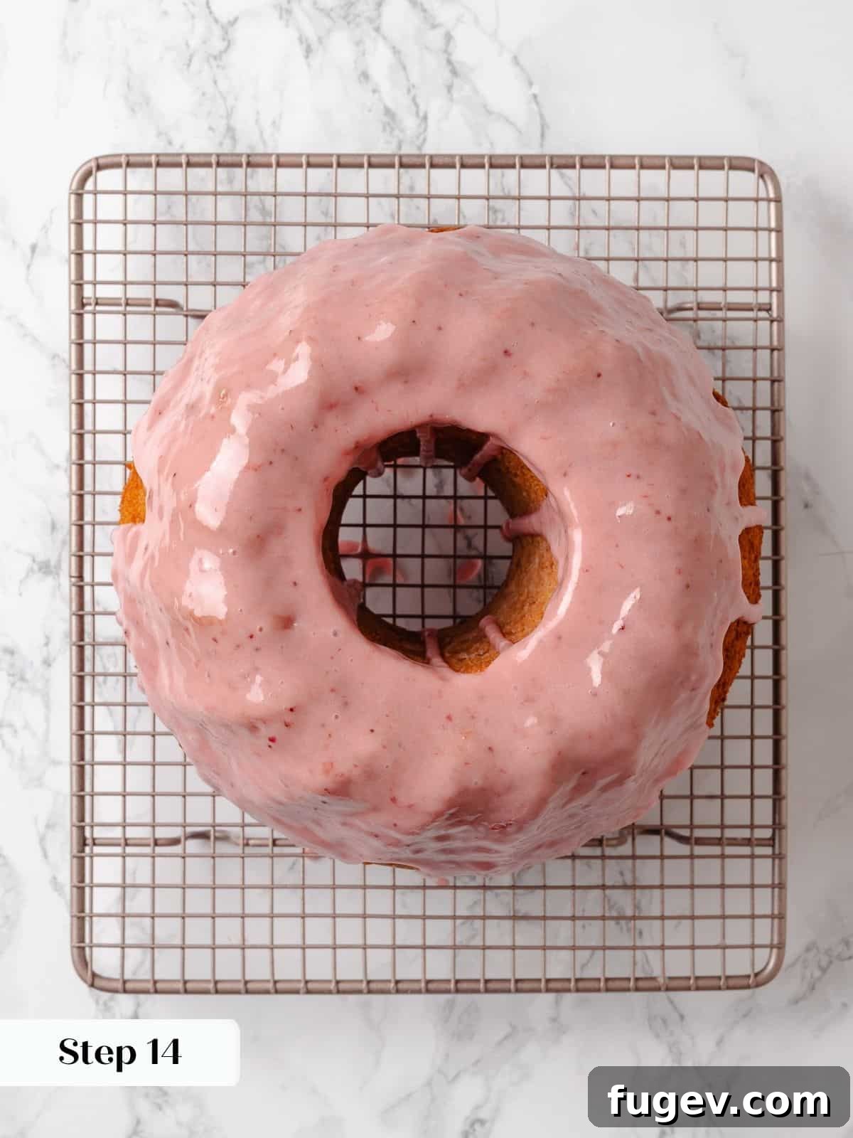 Strawberry Bliss Pound Cake 19 A fully baked and glazed strawberry pound cake resting on a wire rack, allowing the vibrant pink glaze to set beautifully before serving.