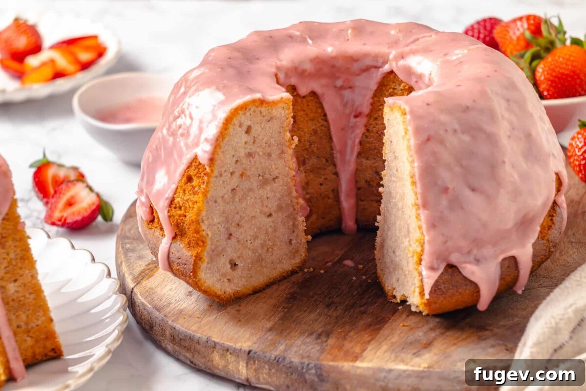 Strawberry Bliss Pound Cake 3 A close-up of a perfectly moist strawberry pound cake, sliced to reveal its soft, buttery interior and tender, dense crumb, inviting a taste.