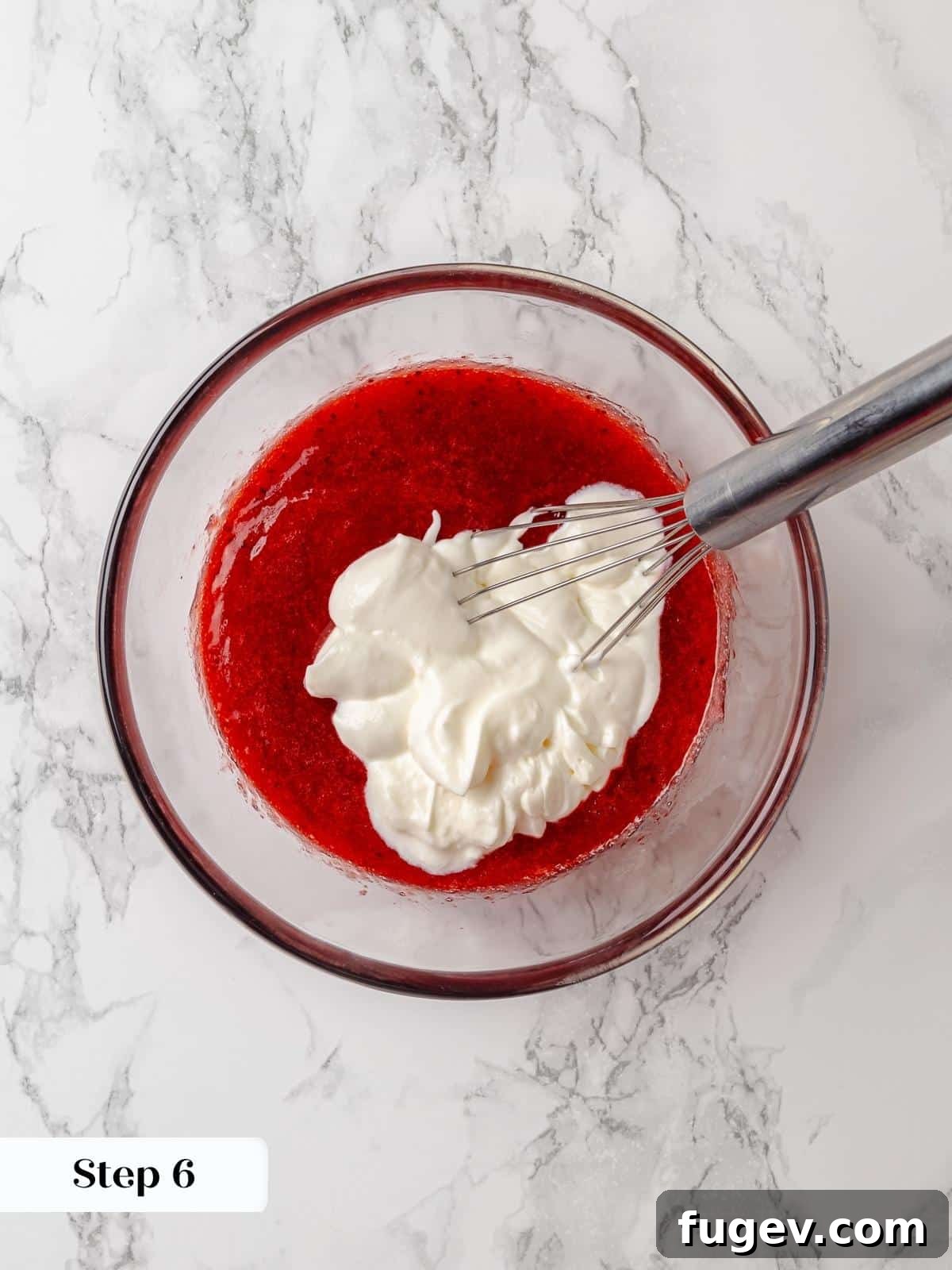 Strawberry Bliss Pound Cake 9 Creamy sour cream being gently folded into the vibrant strawberry jam, creating a harmonious and flavorful mixture for the cake batter.