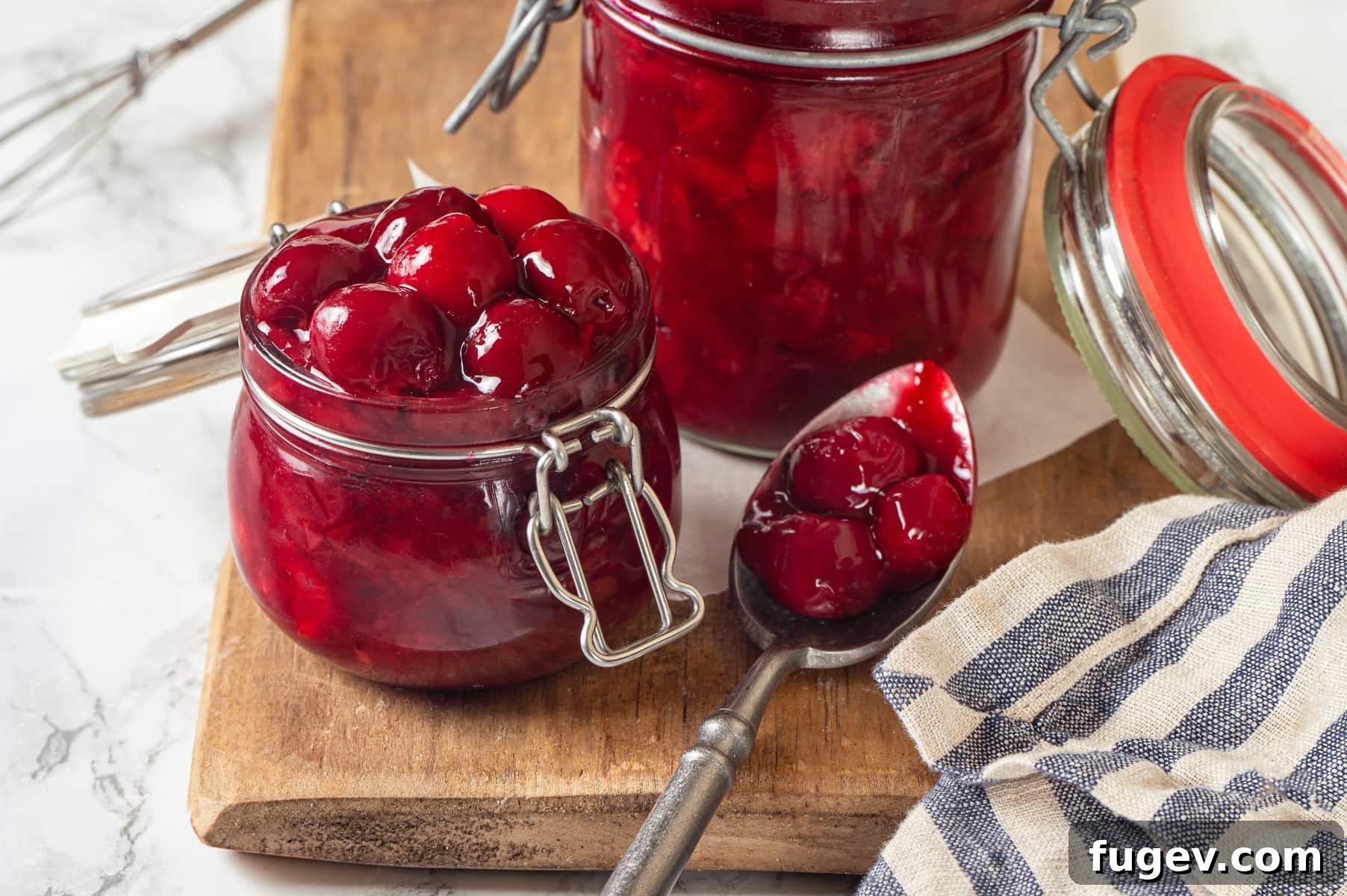 Homemade Cherry Pie Filling Perfection 3 Thick, glossy cherry pie filling clings to spoon, showing texture and visible chunks of fruit, ready to be used in baking.