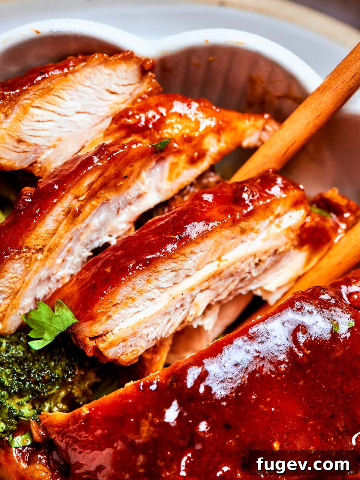 Gochujang Glazed Chicken 2 Chicken breasts and thighs sliced after cooking, covered in red sauce and plated.