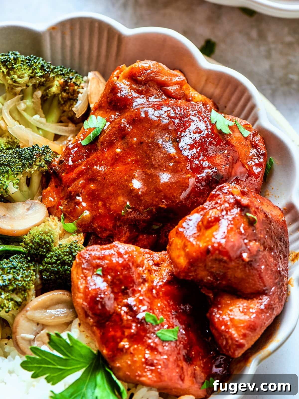 Gochujang Glazed Chicken 12 Bold red gochujang sauce in a bowl with browned chicken and softened onions.