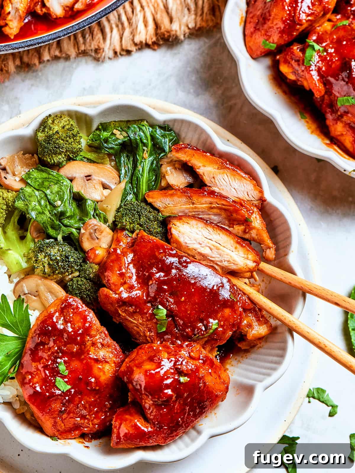 Gochujang Glazed Chicken 13 Bright green broccoli florets mingling with sauced chicken and mushrooms in stir-fry serving.