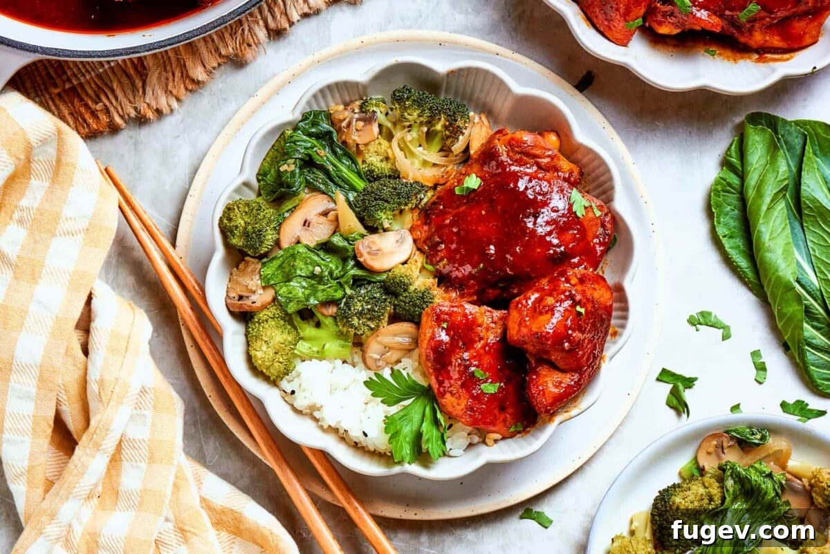 Gochujang Glazed Chicken 4 Gochujang chicken served with vegetables and rice on a white table with natural light.