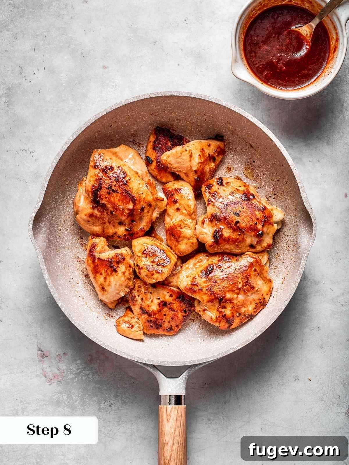 Gochujang Glazed Chicken 9 Chicken browning in a skillet before adding gochujang sauce, showing crispy golden sear.