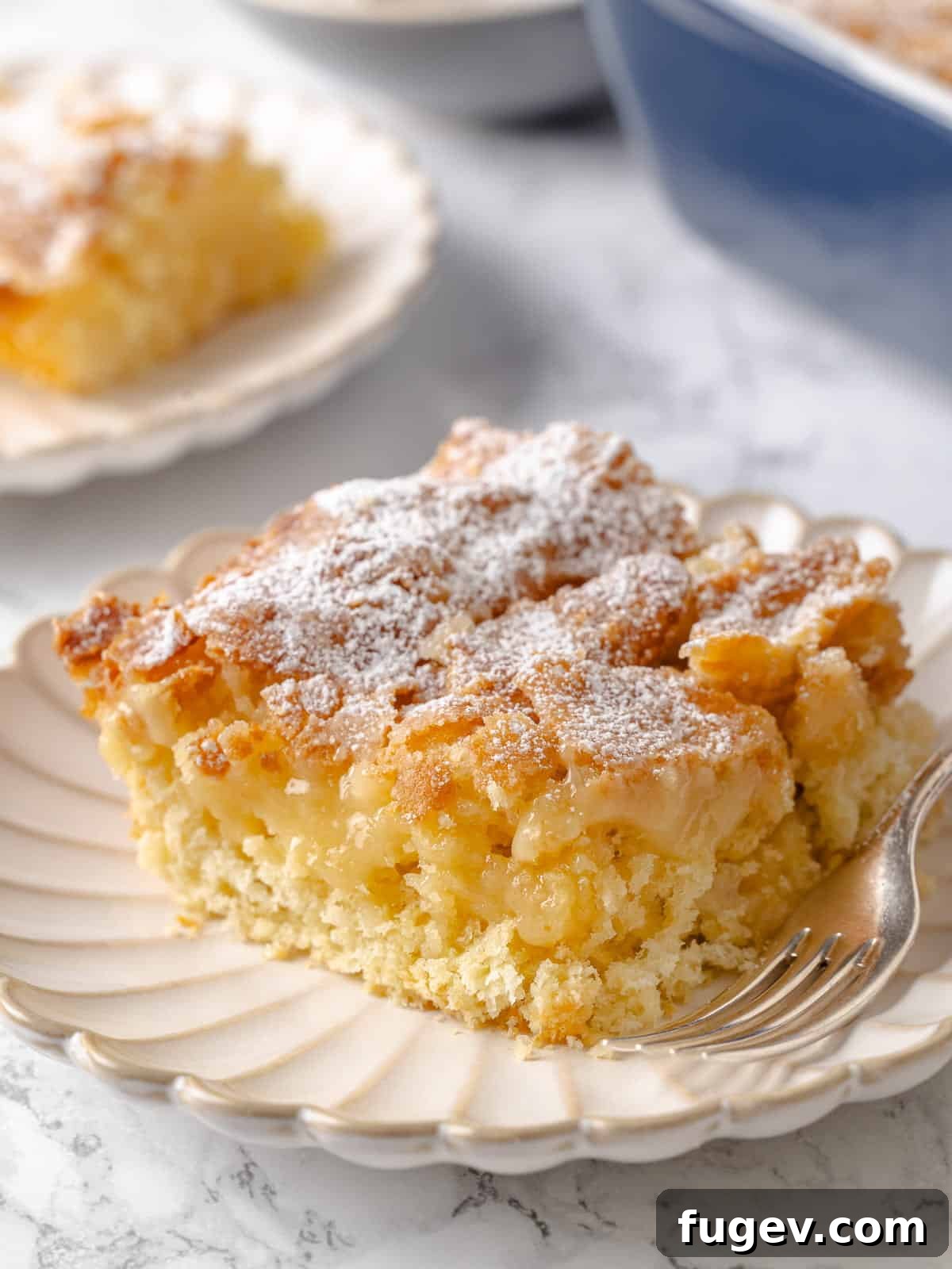 Melted Butter Dream 2 A visibly gooey middle sits beneath the crusty top of this traditional St. Louis gooey butter cake, highlighting its signature texture.