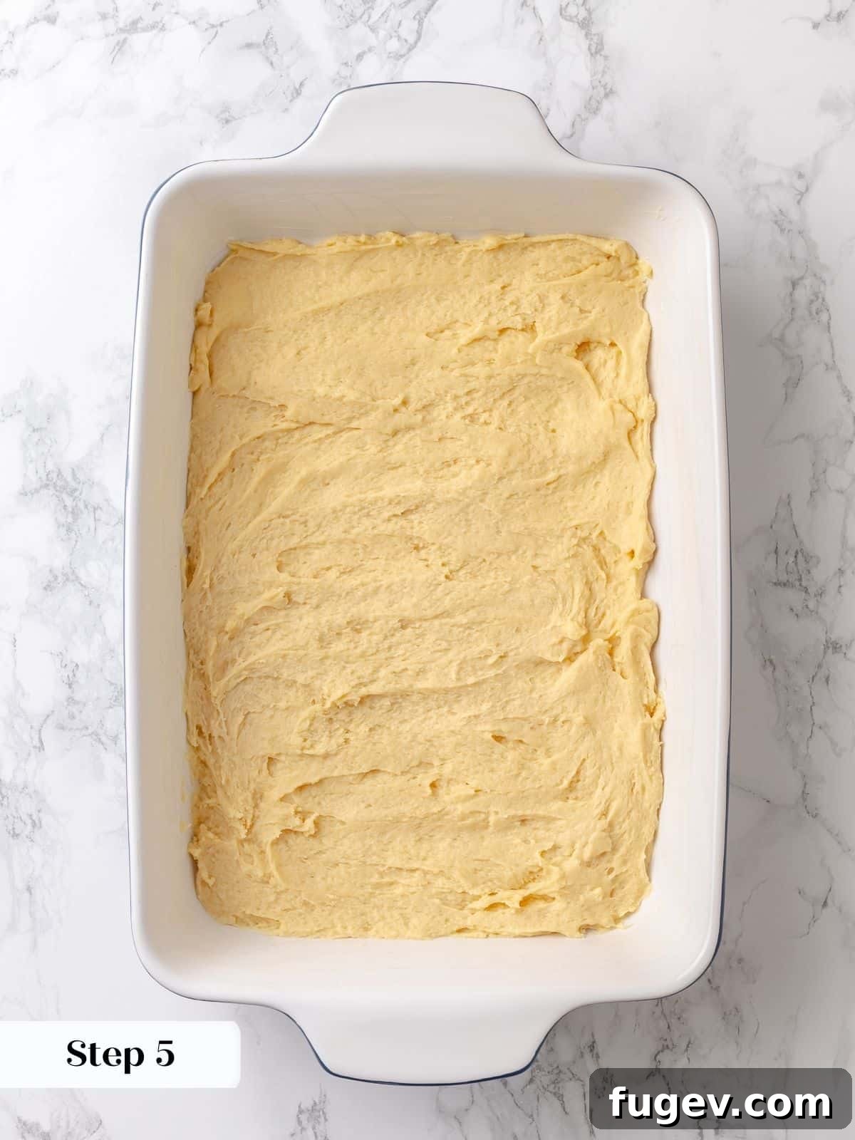 Melted Butter Dream 11 The cake dough has risen notably in the pan, indicating successful proofing and readiness for the sweet sugar topping.