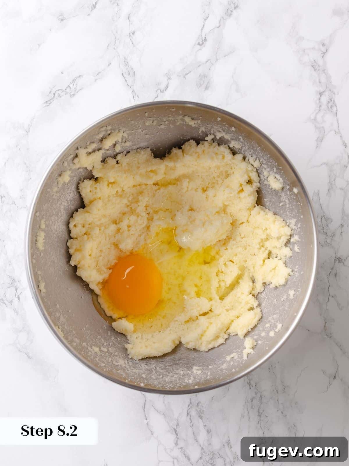 Melted Butter Dream 14 An egg is cracked directly into the creamed butter and sugar mixture, ready to be blended for the cake topping.