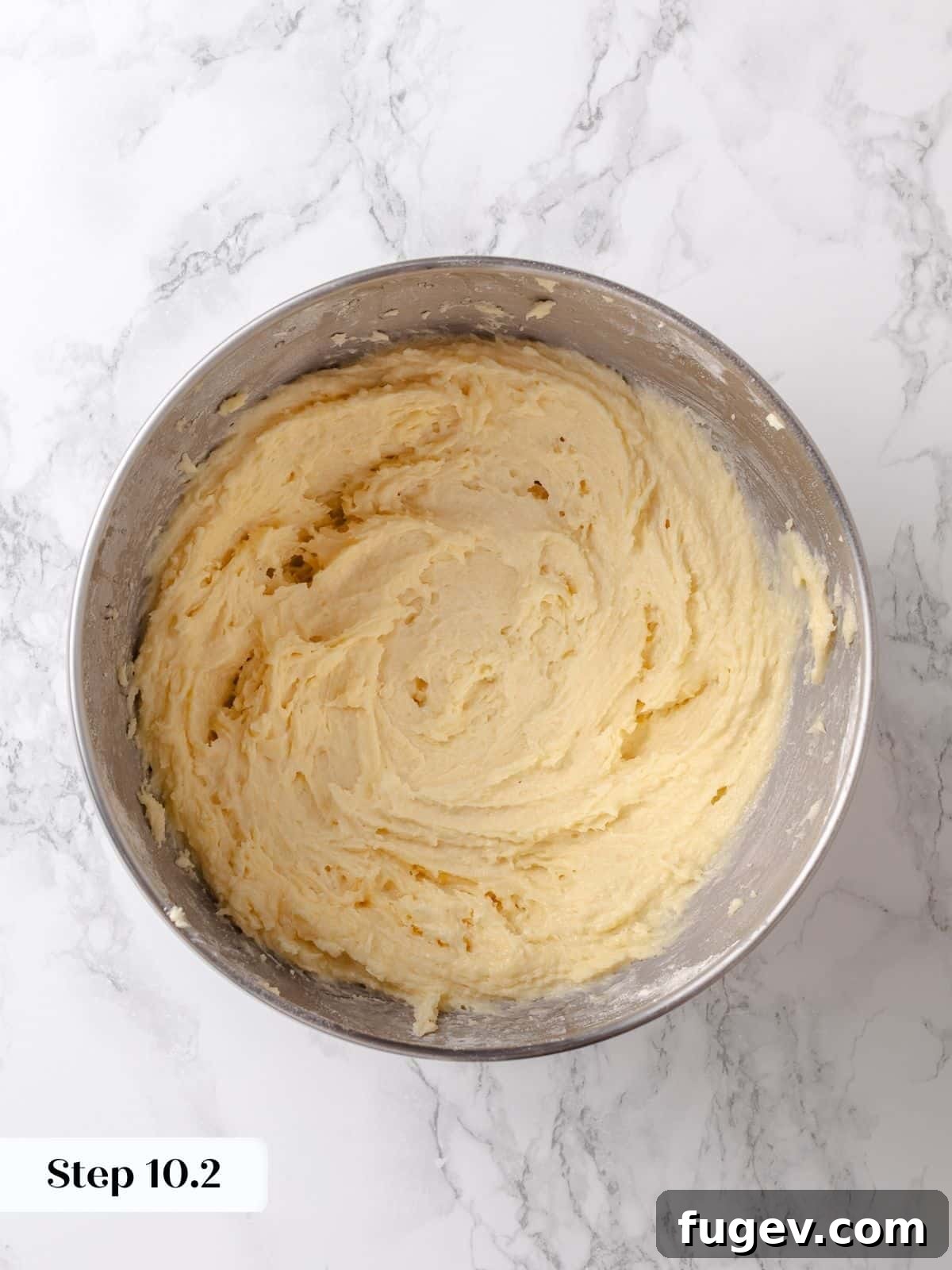 Melted Butter Dream 18 Thick, rich sugar batter is fully mixed to a smooth consistency, poised and ready to be spread over the prepared cake base.