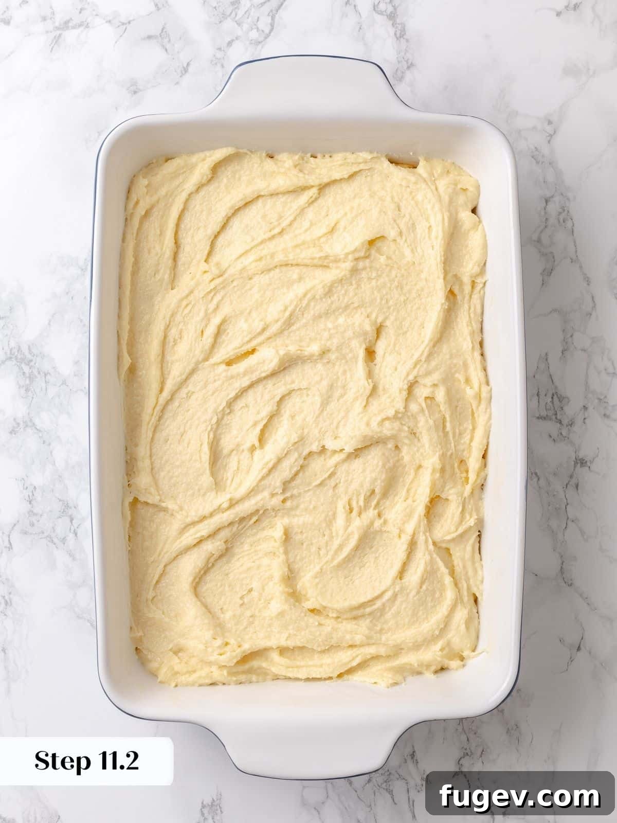 Melted Butter Dream 20 The gooey topping layer meticulously covers the entire cake base, prepared to bake into its characteristic, irresistible texture.