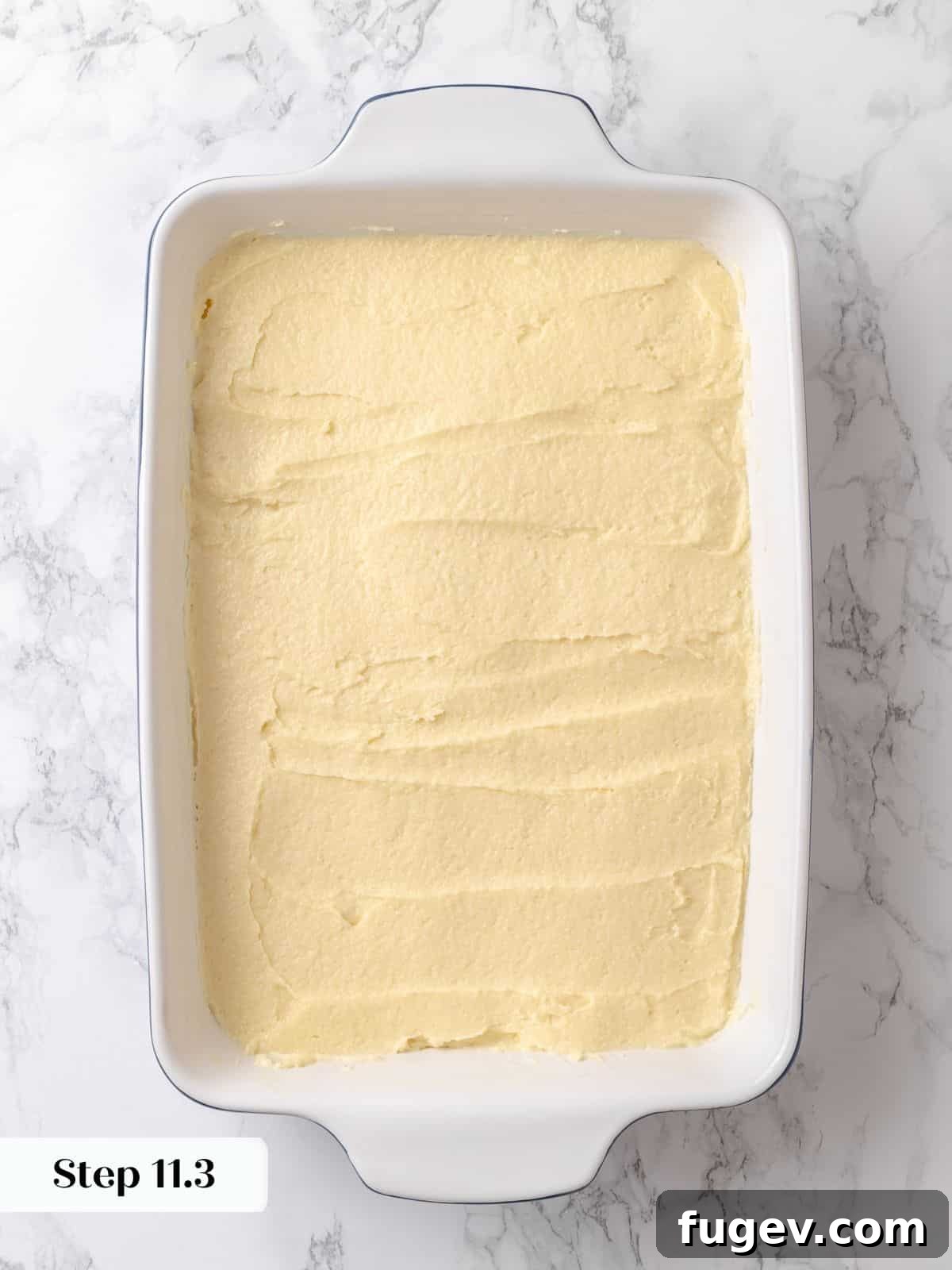 Melted Butter Dream 21 Soft batter spread evenly to the edges of the baking dish, ready for proofing and the addition of its topping.