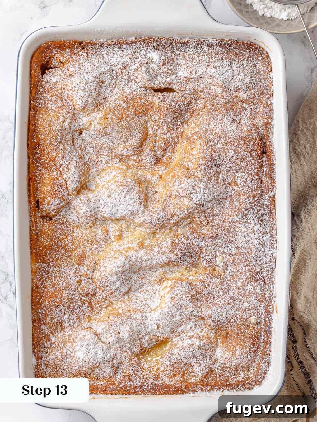 Melted Butter Dream 23 A generous, thick layer of powdered sugar is dusted over the top of the baked gooey butter cake, completing its classic presentation.