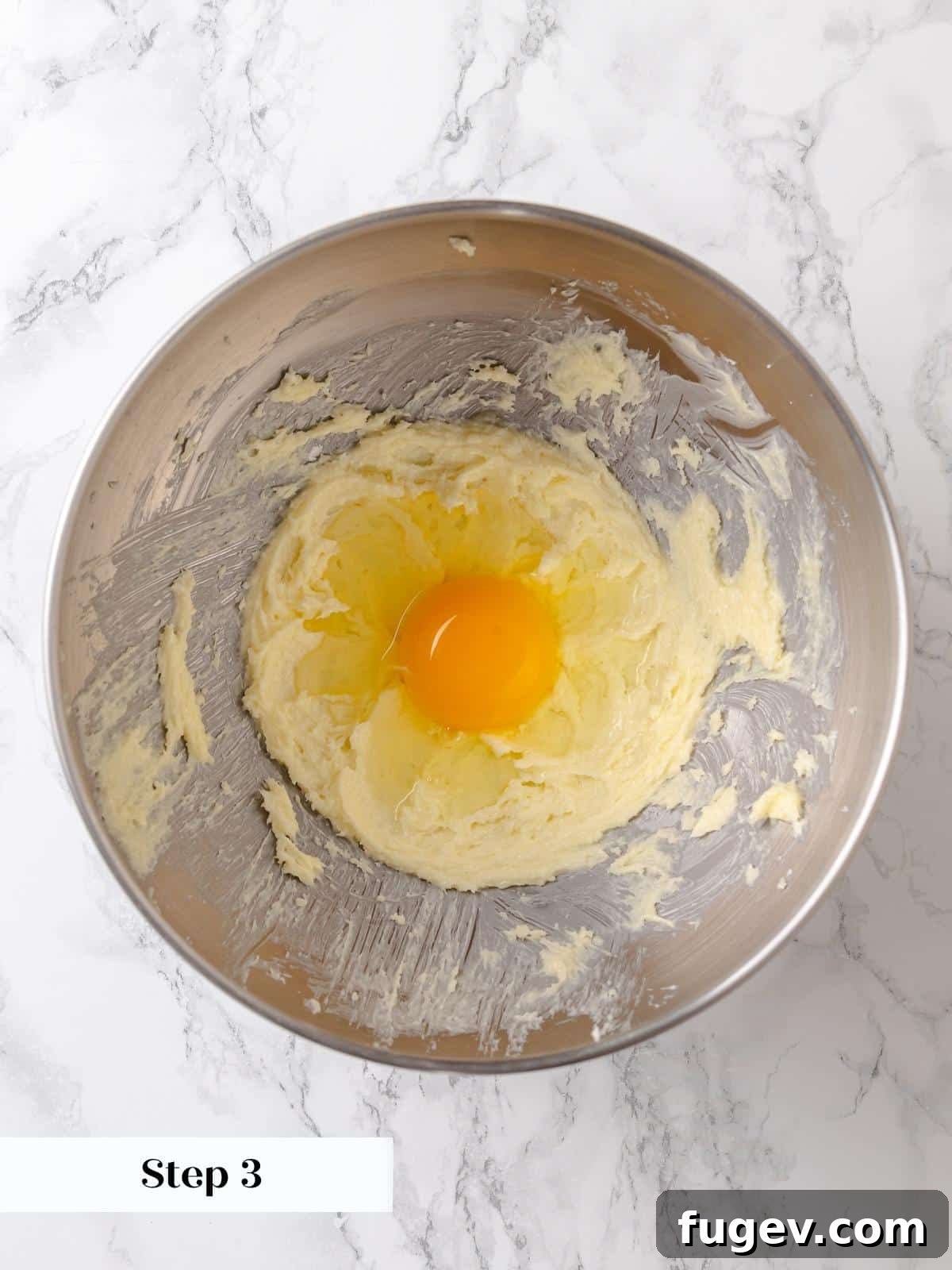 Melted Butter Dream 7 A single egg is smoothly incorporated into the creamed butter and sugar batter, adding essential moisture and richness.