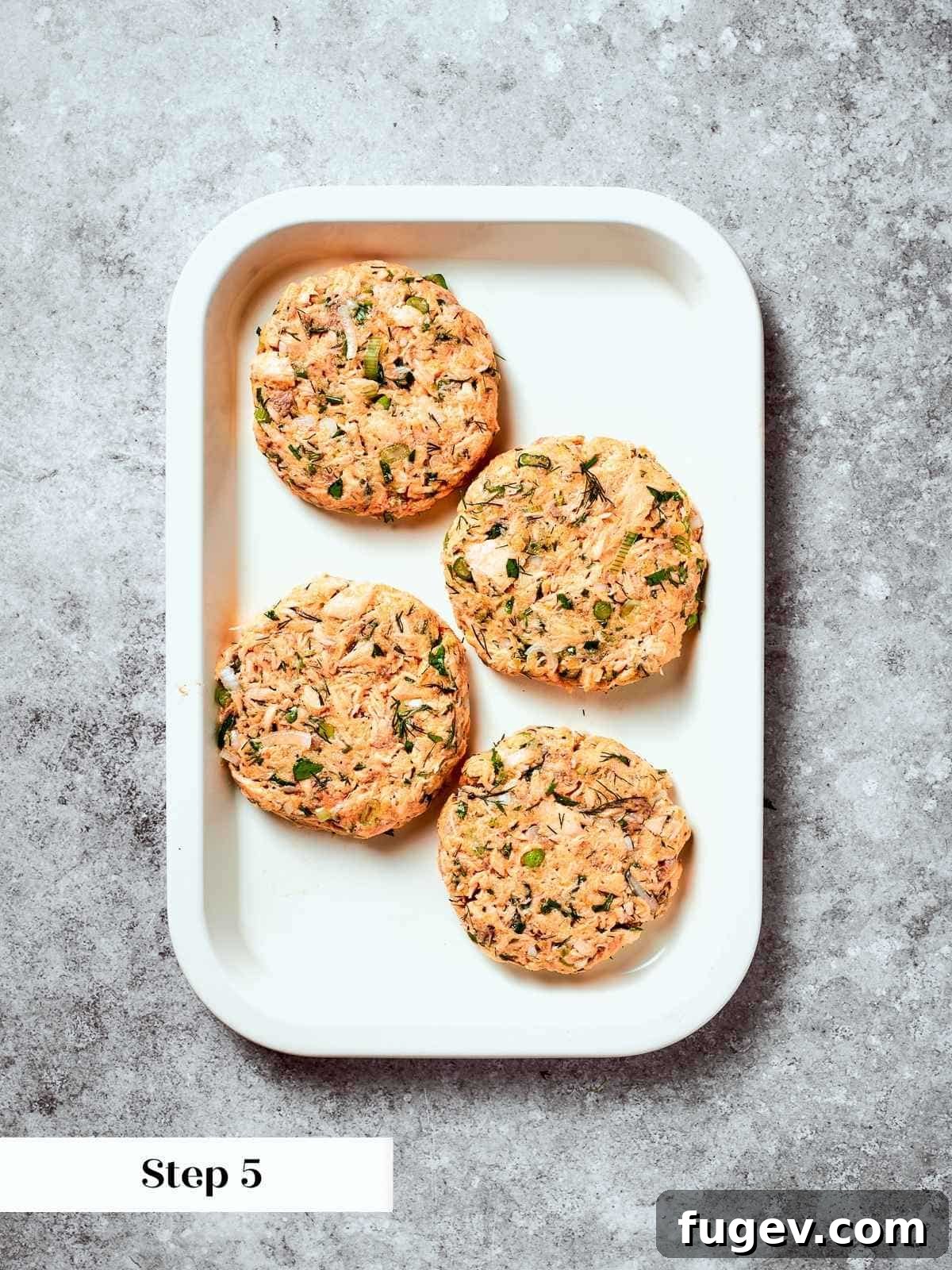 Gourmet Salmon Burgers 8 Formed salmon burger patties arranged on tray, prepped for chilling or cooking.