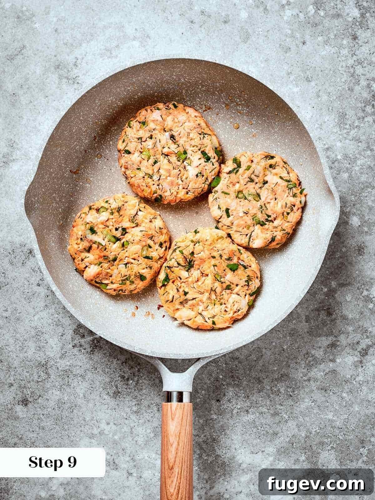 Gourmet Salmon Burgers 10 Salmon burger patties sizzling in a pan, developing golden brown crust.