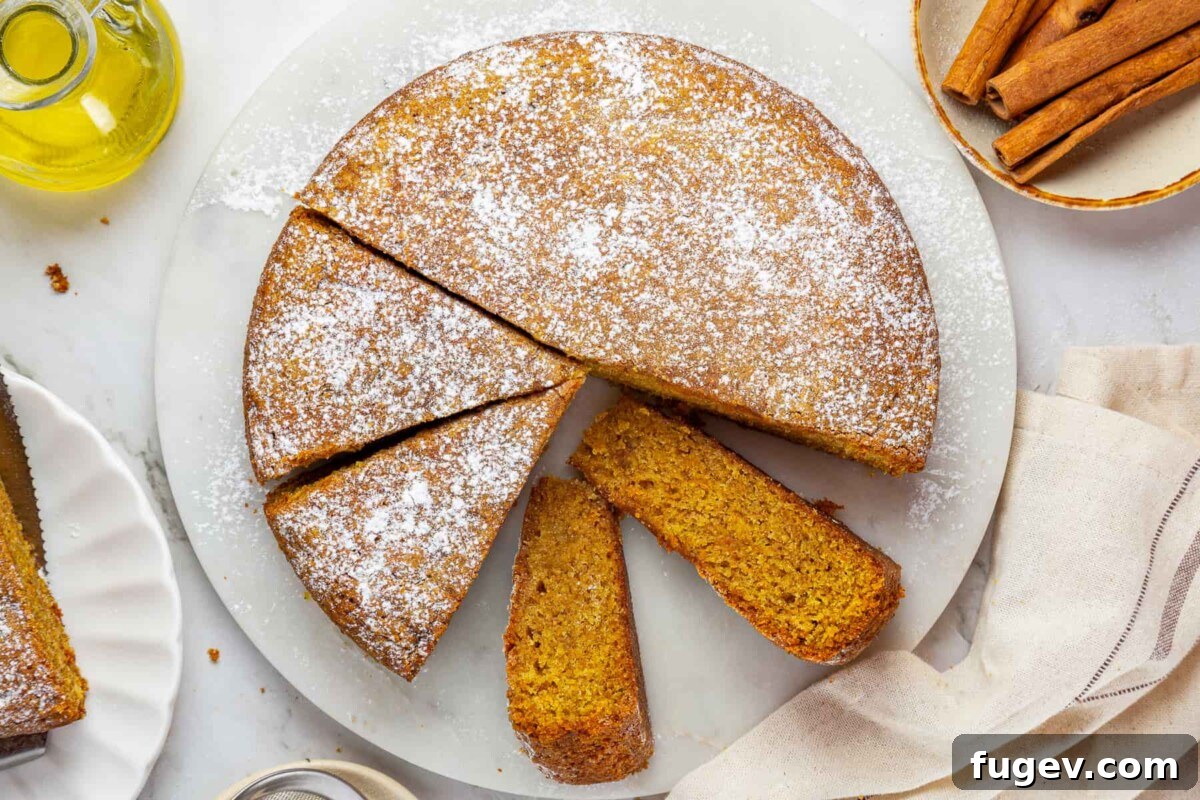 Velvety Pumpkin Olive Oil Cake 4 A perfectly moist pumpkin cake, freshly sliced to highlight its tender interior and the balanced blend of aromatic fall spices throughout. A quintessential easy pumpkin cake.