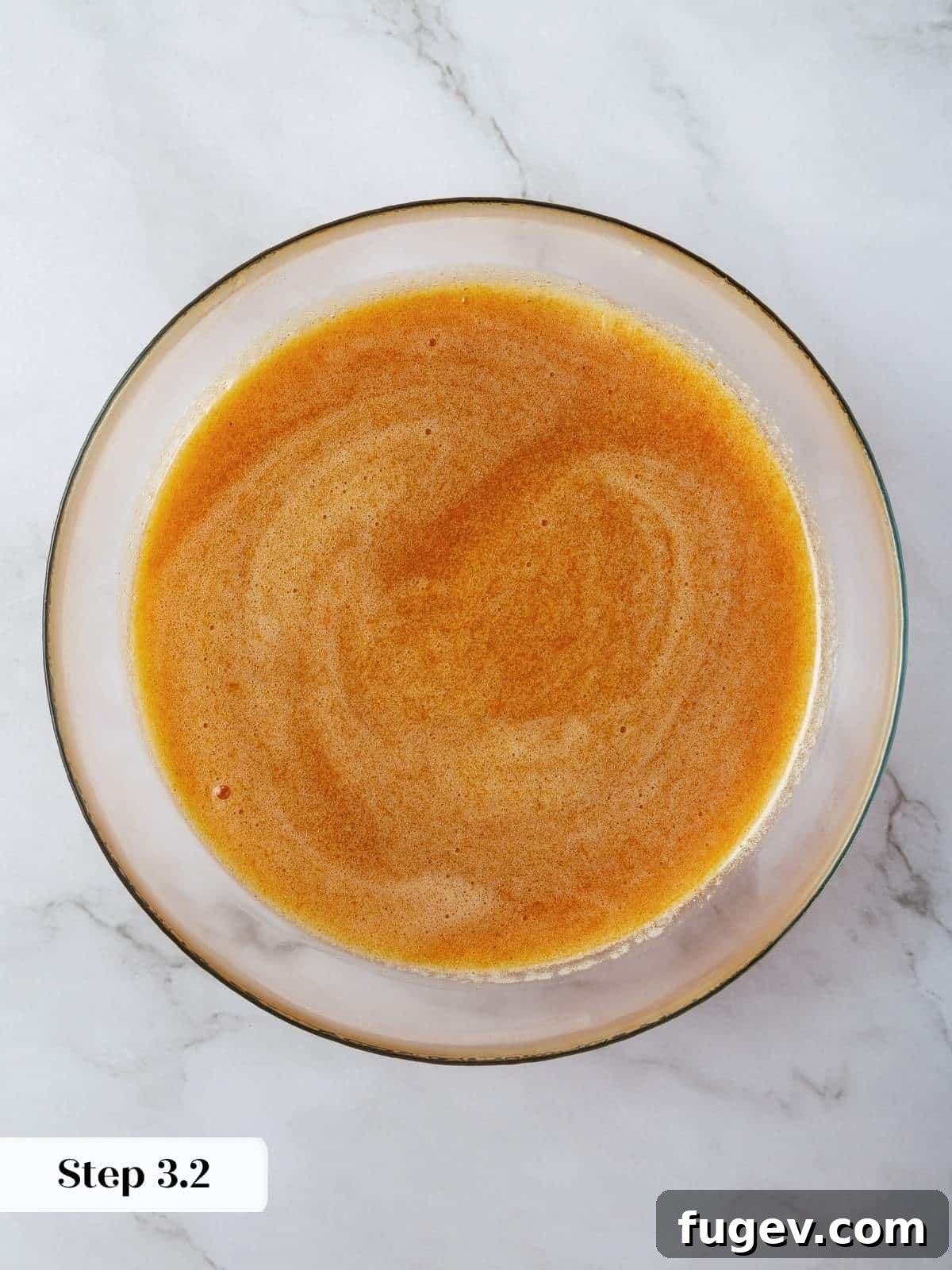 Velvety Pumpkin Olive Oil Cake 7 The wet ingredients, including olive oil, pumpkin, sugar, and eggs, are fully emulsified in a mixing bowl, creating a silky smooth, vibrant orange pumpkin base ready for dry ingredients.