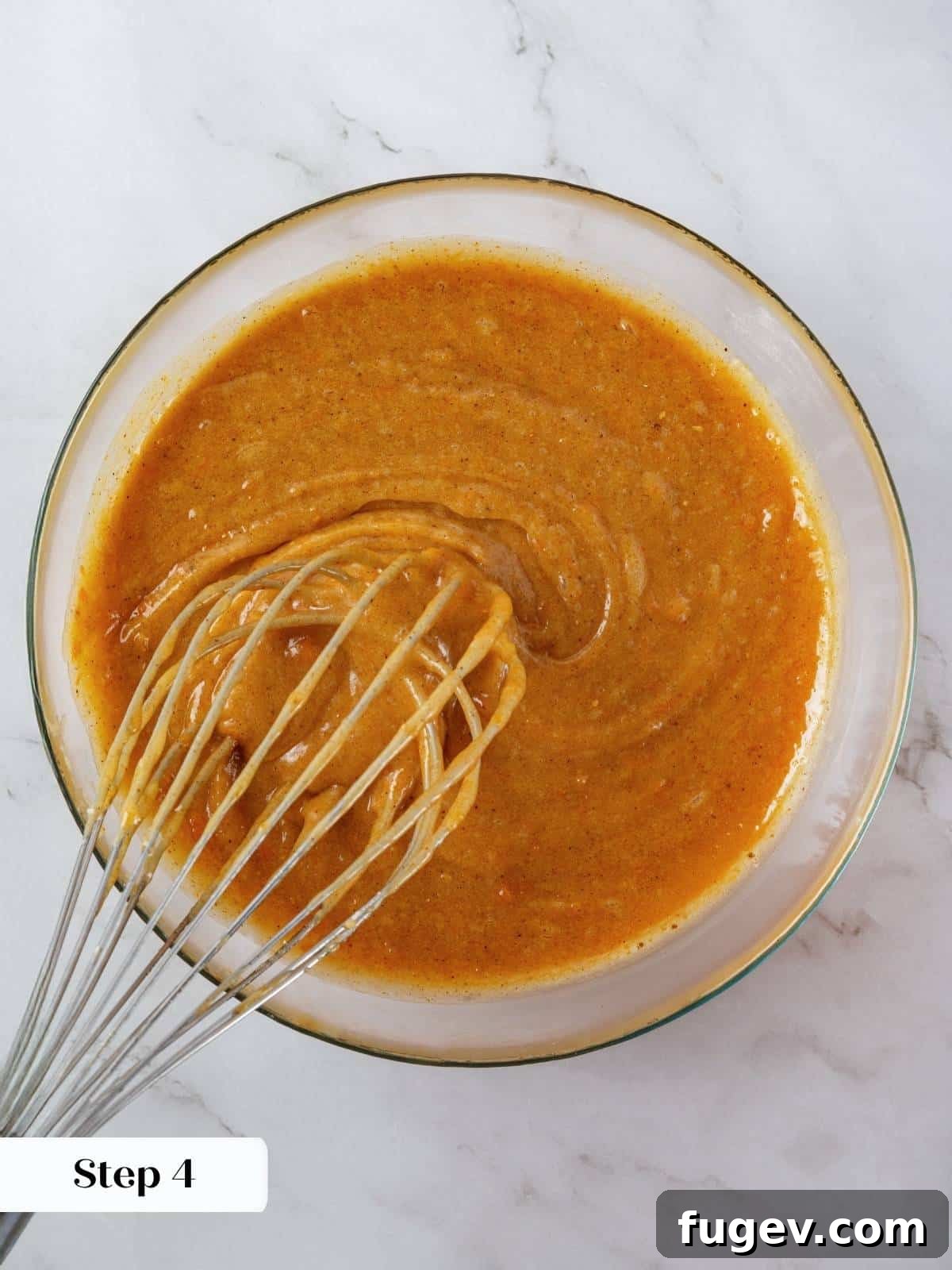Velvety Pumpkin Olive Oil Cake 8 The spiced pumpkin batter, now glossy and a rich orange hue, is expertly swirled in a large mixing bowl, showcasing its smooth consistency before being poured for baking.