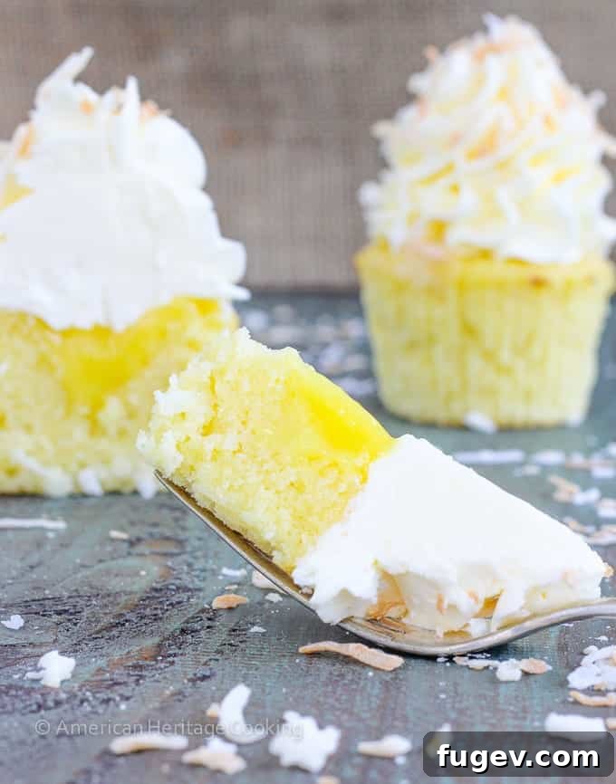 Tropical Lemon Coconut Cupcakes 4 In these Lemon Coconut Cupcakes a moist coconut cupcake that is made with both dried coconut and coconut milk is filled with lemon curd and then topped with a coconut Italian Meringue Buttercream. And then topped off with some more toasted coconut.