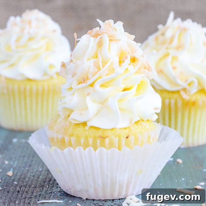 Tropical Lemon Coconut Cupcakes 5 In these Lemon Coconut Cupcakes a moist coconut cupcake that is made with both dried coconut and coconut milk is filled with lemon curd and then topped with a coconut Italian Meringue Buttercream. And then topped off with some more toasted coconut.