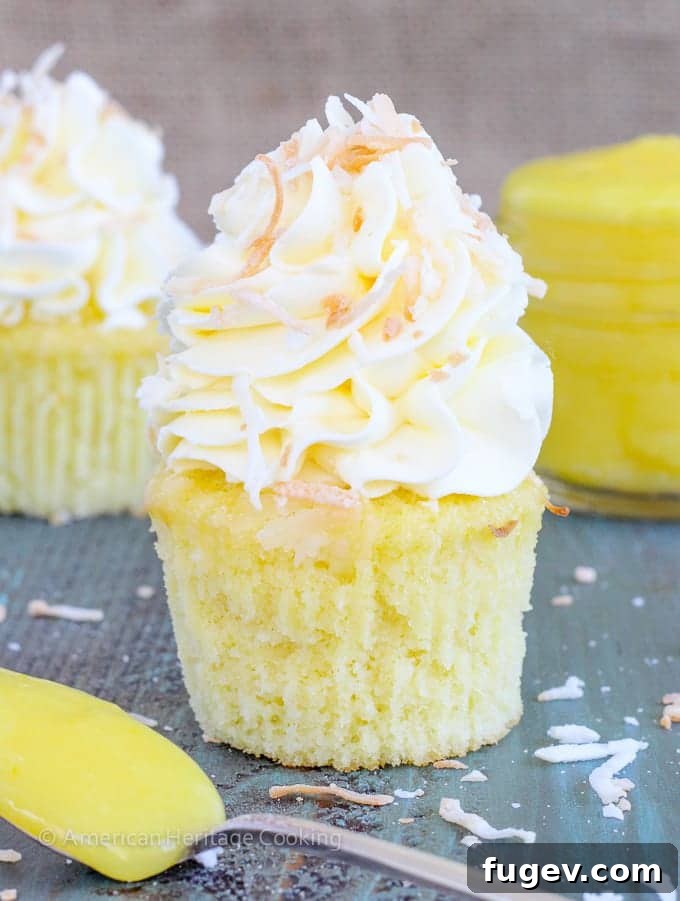Tropical Lemon Coconut Cupcakes 6 In these Lemon Coconut Cupcakes a moist coconut cupcake that is made with both dried coconut and coconut milk is filled with lemon curd and then topped with a coconut Italian Meringue Buttercream. And then topped off with some more toasted coconut.