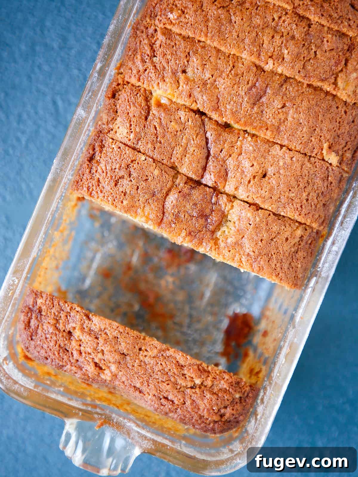 The Ultimate Moist Banana Bread 5 Whole loaf of golden-brown banana bread still in a clear glass baking dish, showing its perfectly baked edges.