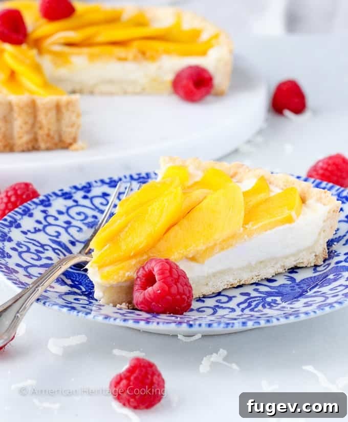Tropical Mango Coconut Dream 7 A close-up of a slice of Coconut Mango Tart, revealing its creamy layers and crispy crust.