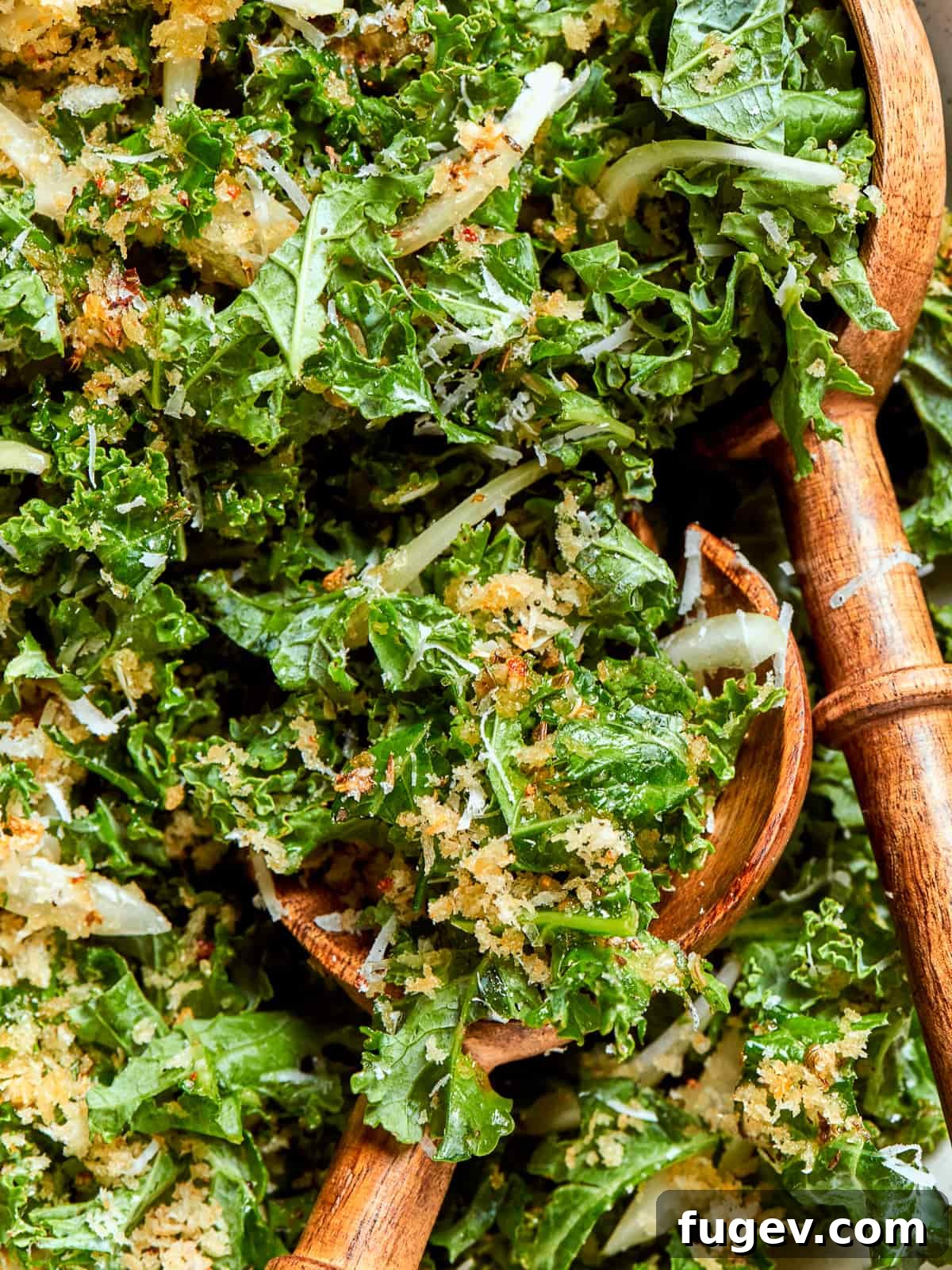 Vibrant Tuscan Kale Delight 2 A spoonful of Tuscan kale salad showing tender ribbons of kale, onions, and crispy breadcrumbs, highlighting its vibrant texture.