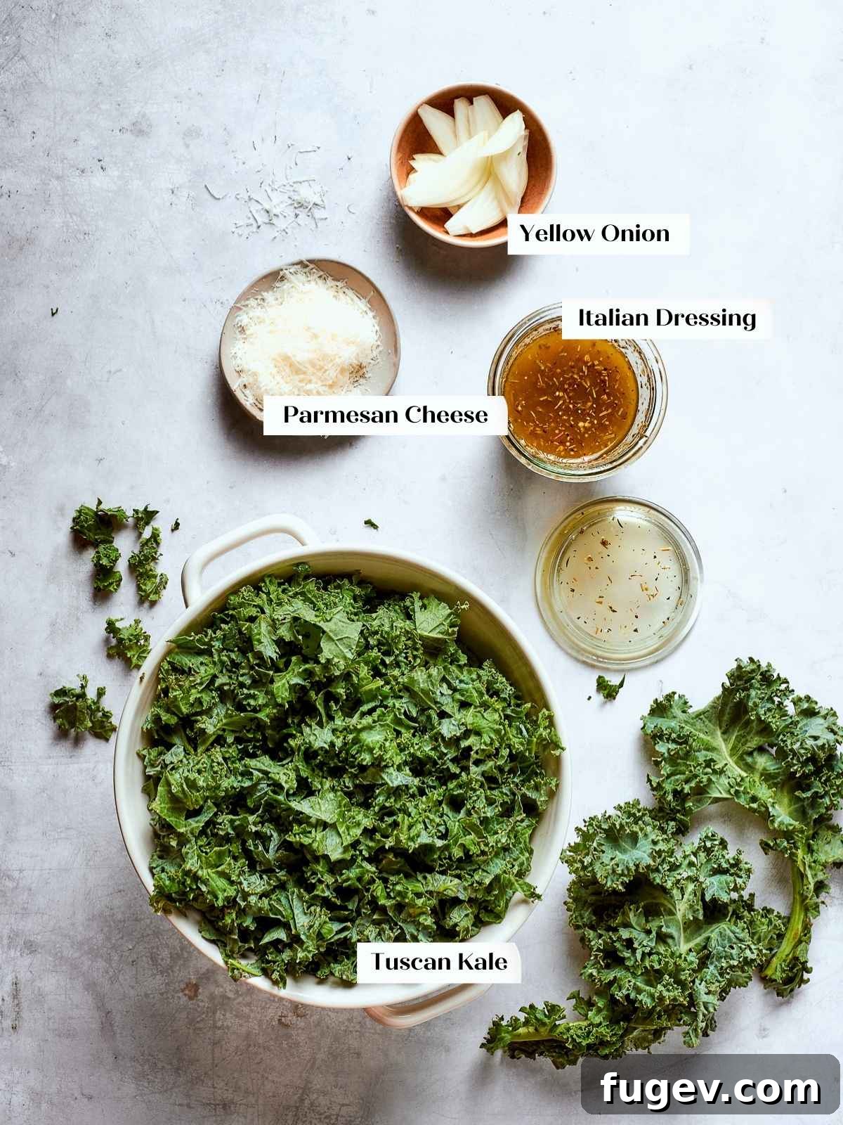 Vibrant Tuscan Kale Delight 5 Tuscan kale salad ingredients prepped on a kitchen counter, with kale, onions, and cheese ready to be assembled into a fresh salad.