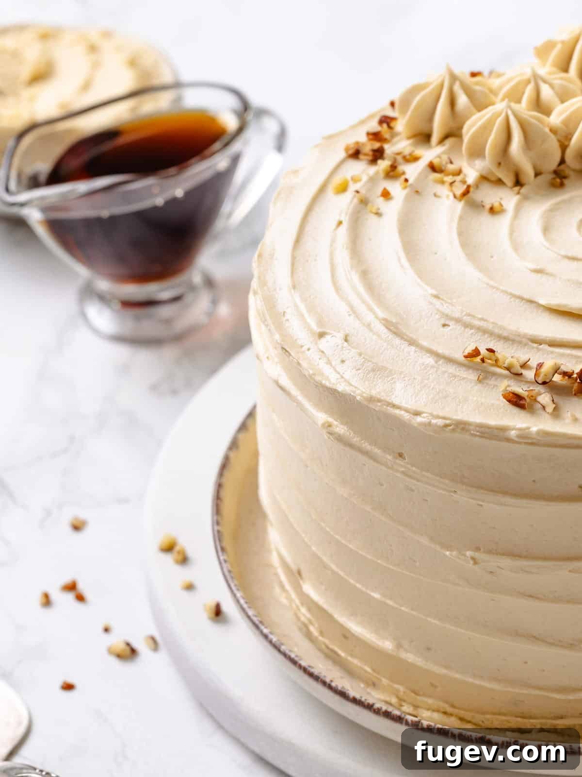 Golden Maple Delight 2 A bowl of fluffy maple frosting with a bottle of pure maple syrup beside it, emphasizing key ingredients.