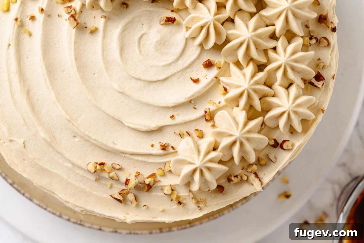 Golden Maple Delight 4 A slice of maple frosting cake adorned with a generous sprinkle of chopped nuts, providing a delightful crunch.
