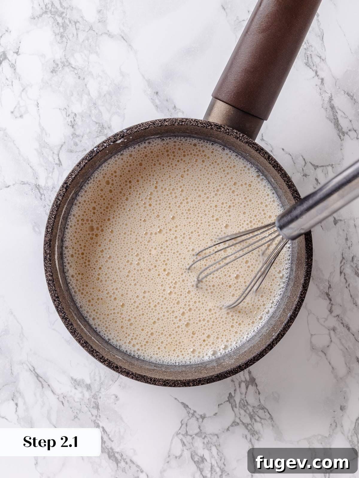 Golden Maple Delight 6 A whisk incorporating milk slowly into the dry flour and sugar mixture in a saucepan.