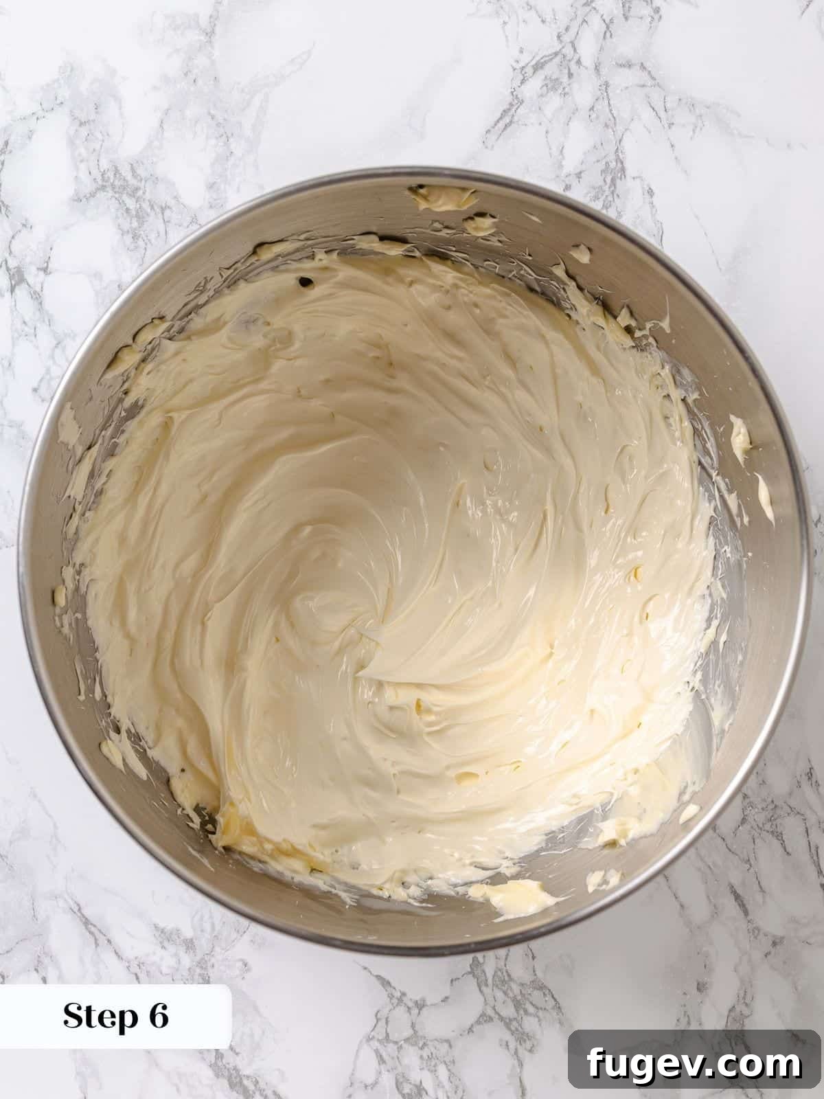 Golden Maple Delight 10 Unsalted butter being beaten in a stand mixer until it becomes light and fluffy.