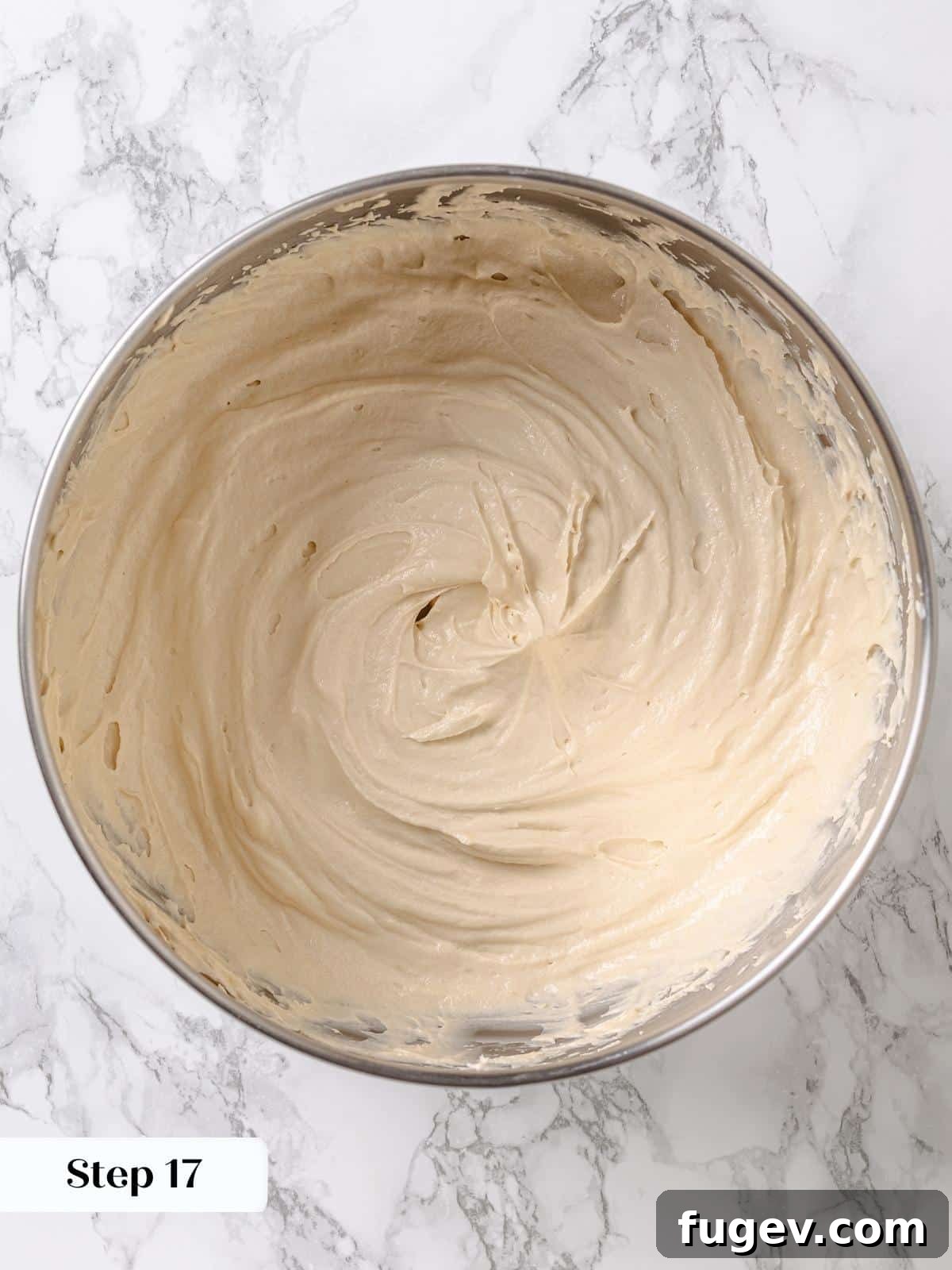 Golden Maple Temptation 17 Finished maple frosting in a mixing bowl, light and fluffy, ready for cake decoration.