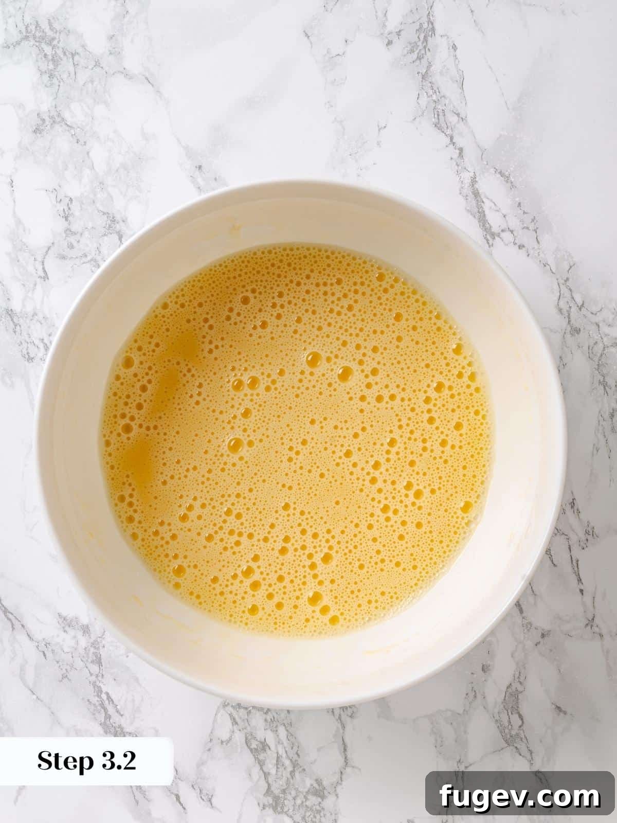 Golden Maple Temptation 7 Oil whisked into eggs until smooth and emulsified, forming the wet base for maple cake batter.