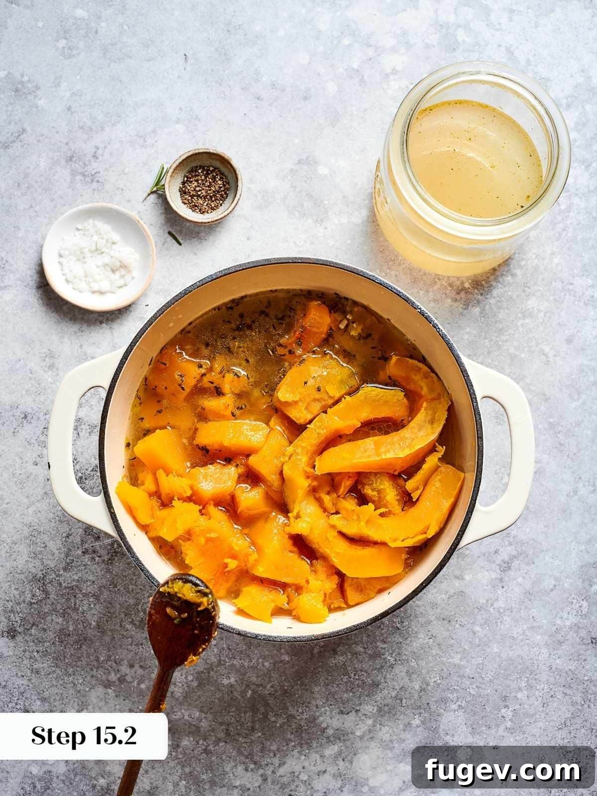Golden Harvest Squash Soup 11 vegetable stock added into pot of cooked squash and aromatics for blending.