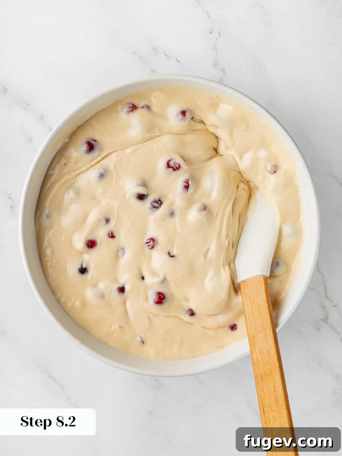 Ultimate Cranberry Cake 7 Thick, prepared cranberry cake batter resting in a mixing bowl, showcasing its creamy texture before being poured into a pan.