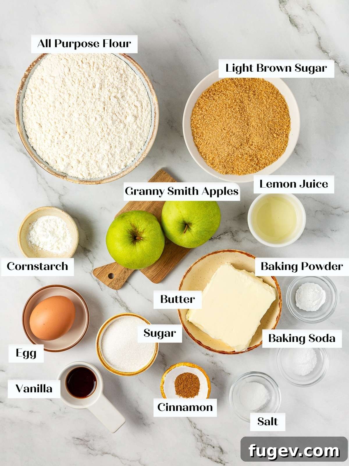 Warm Apple Spice Cookies 3 Essential baking ingredients for homemade apple pie cookies, including fresh Granny Smith apples, all-purpose flour, rich unsalted butter, and aromatic cinnamon, neatly arranged on a clean kitchen counter.