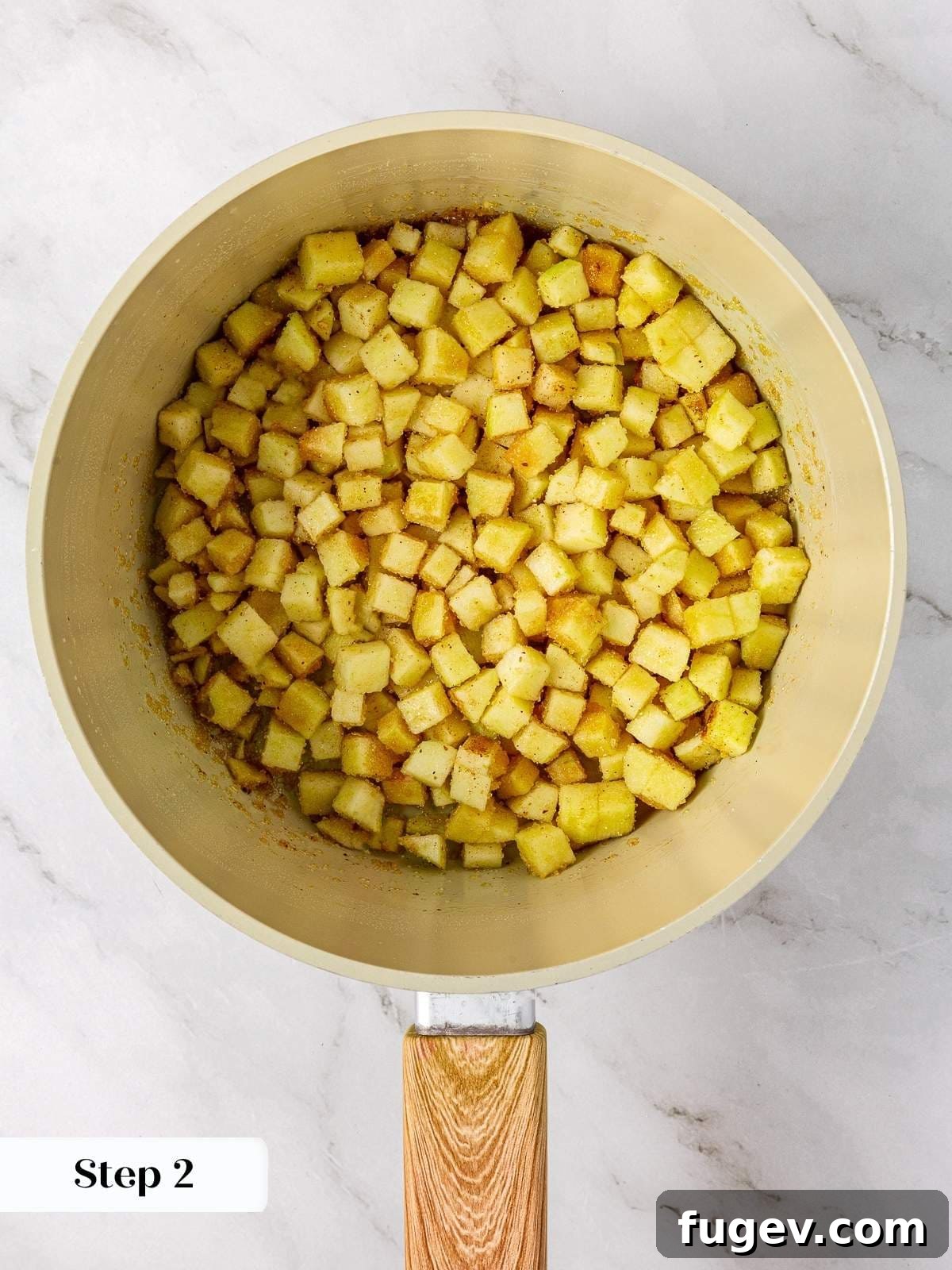 Warm Apple Spice Cookies 5 Chopped apples cooking down with brown sugar, fresh lemon juice, and aromatic cinnamon in a medium saucepan to create the fragrant pie filling base.